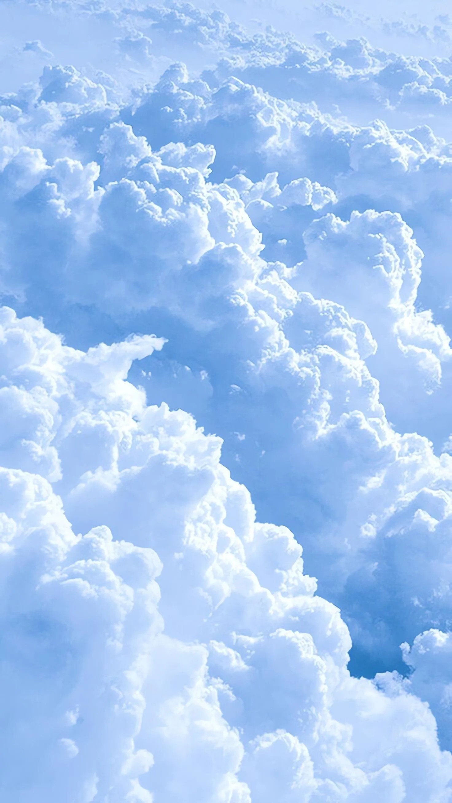 Bright White Clouds Against a Deep Blue Sky Wallpaper
