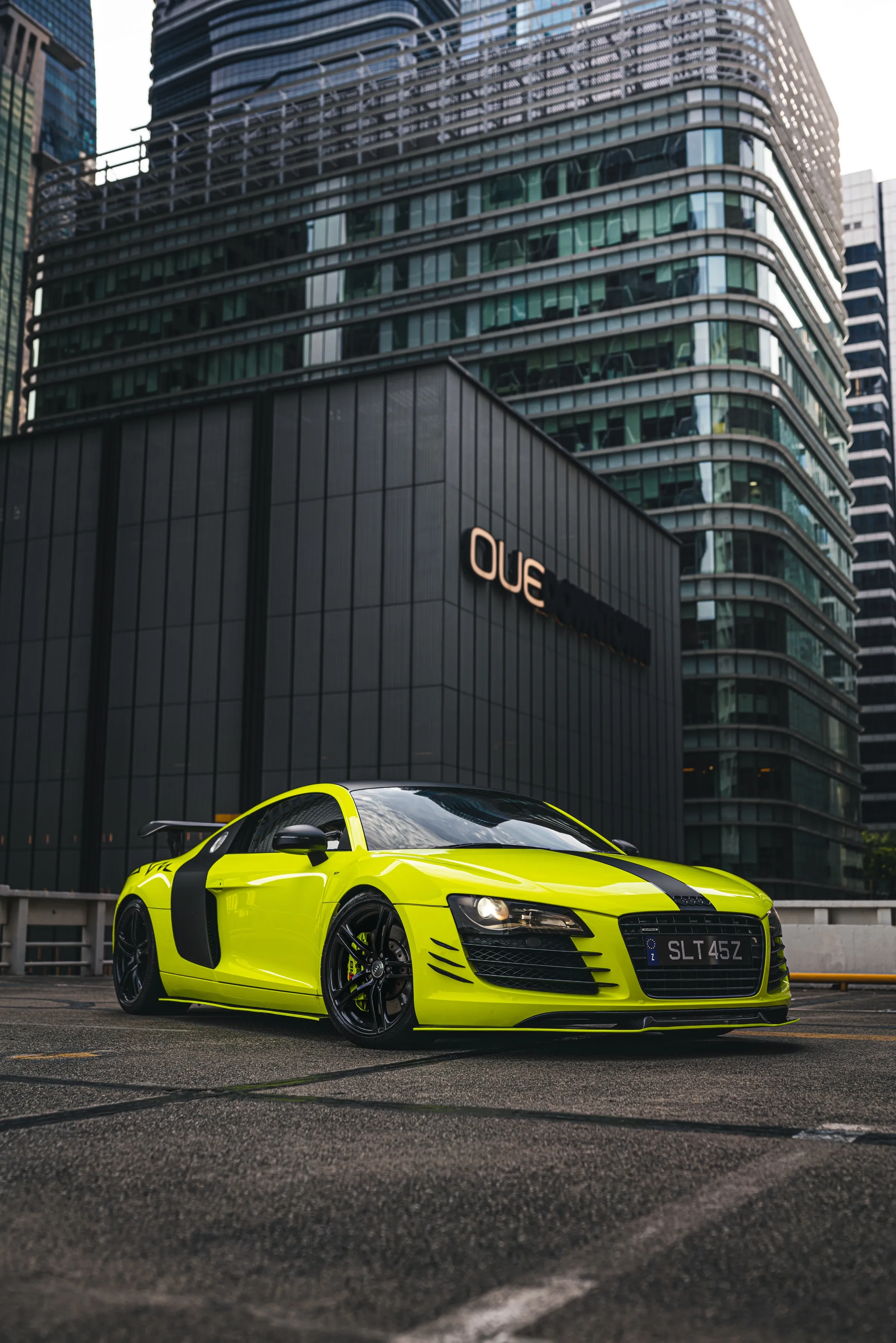 Bright Yellow Sports Car Parked in City Street Wallpaper