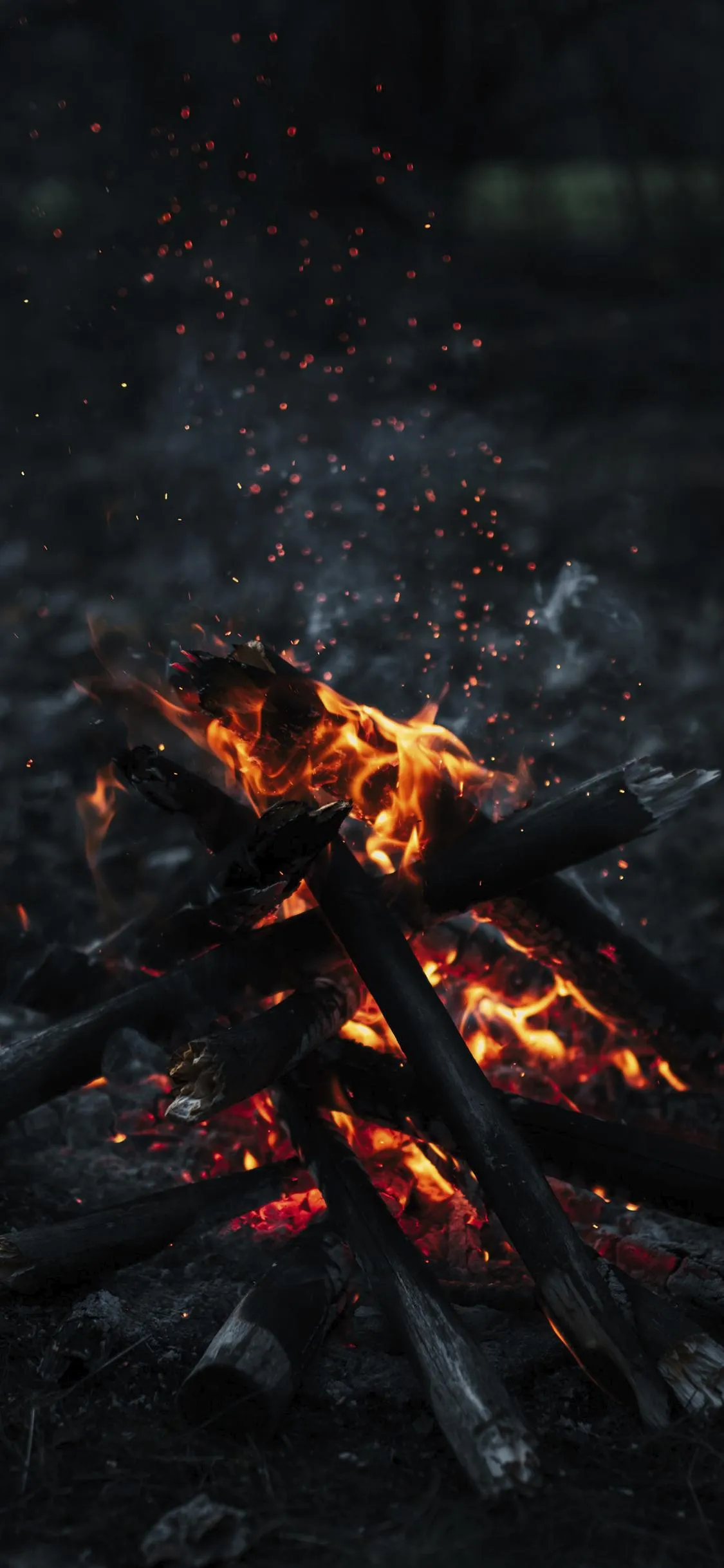 Burning Ember Fire Texture in Dark Environment Wallpaper