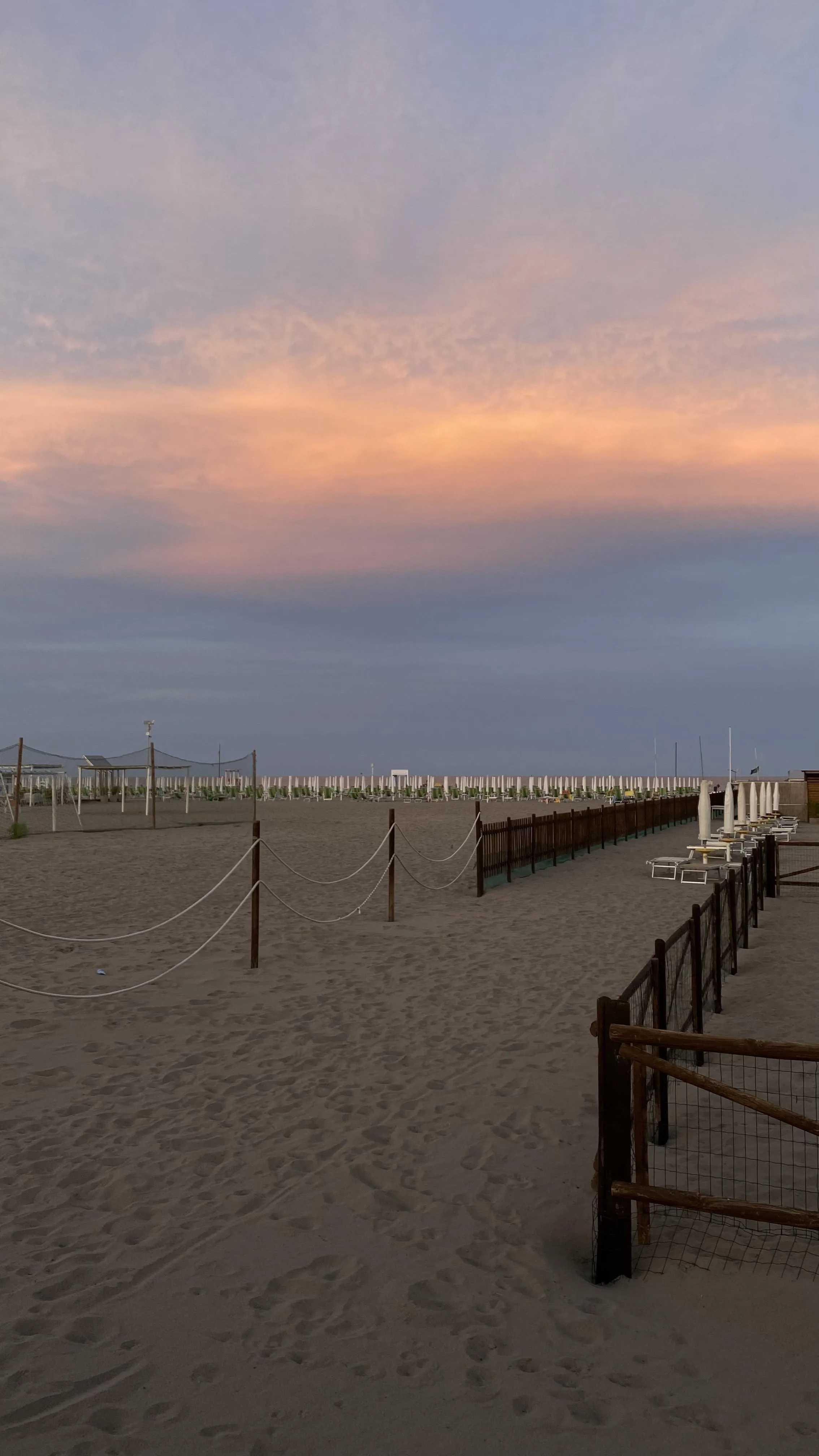 Calm Beach Walkway with Sunset Over Ocean Scene Wallpaper