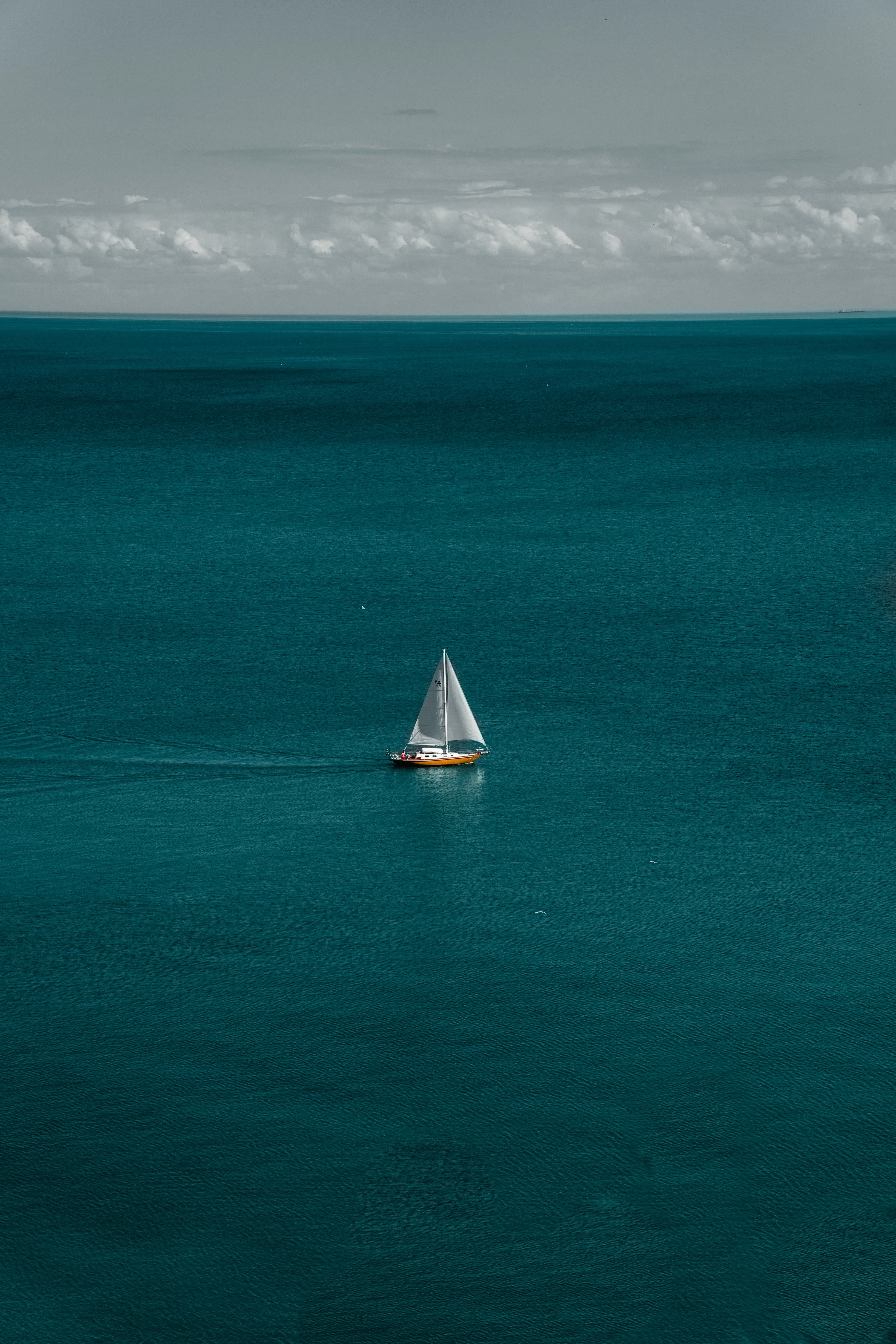 Calm Blue Sea with Lone Sailing Boat Scene Wallpaper