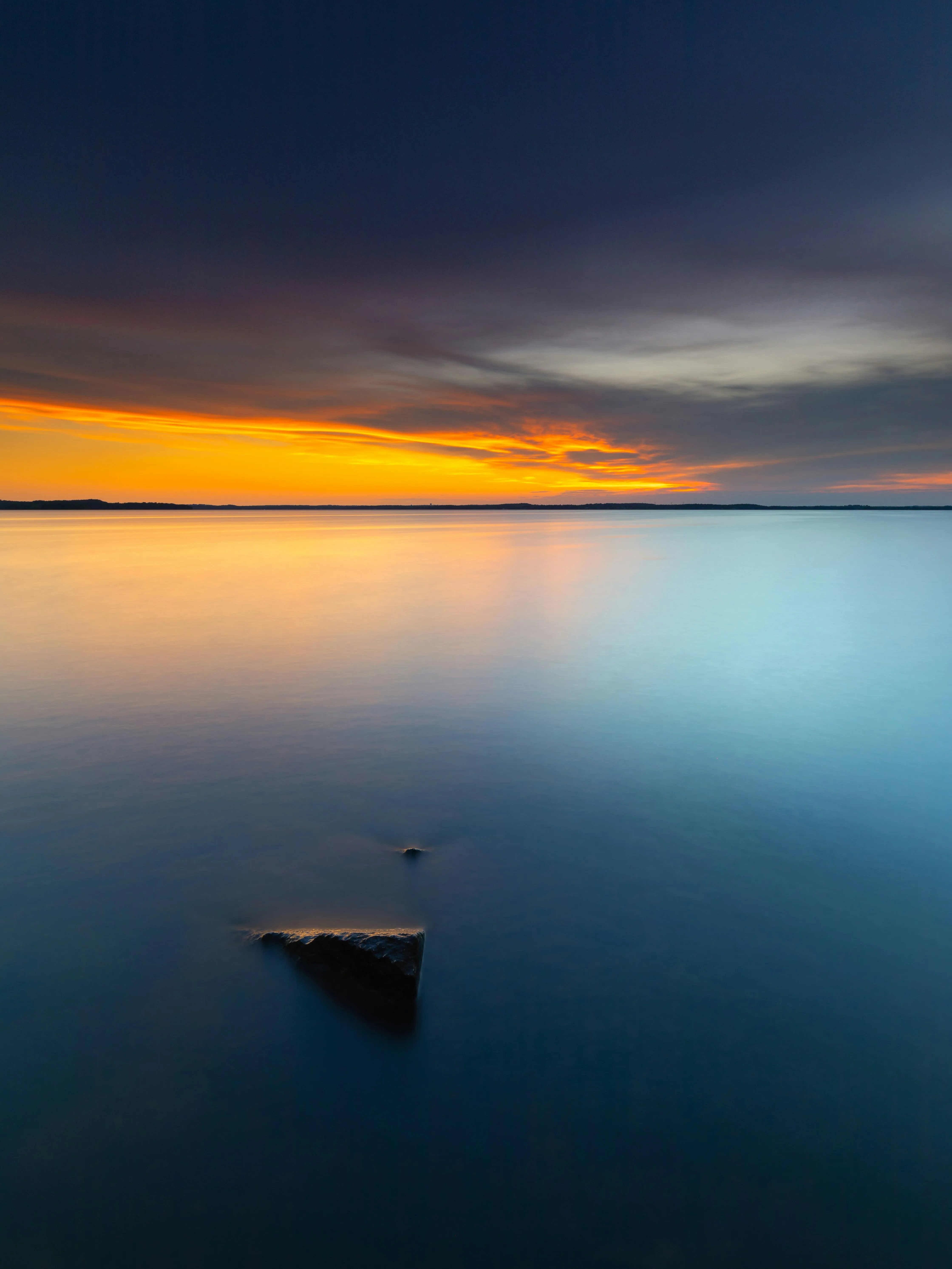 Calm Lake at Sunset with Reflections and Boat View Wallpaper