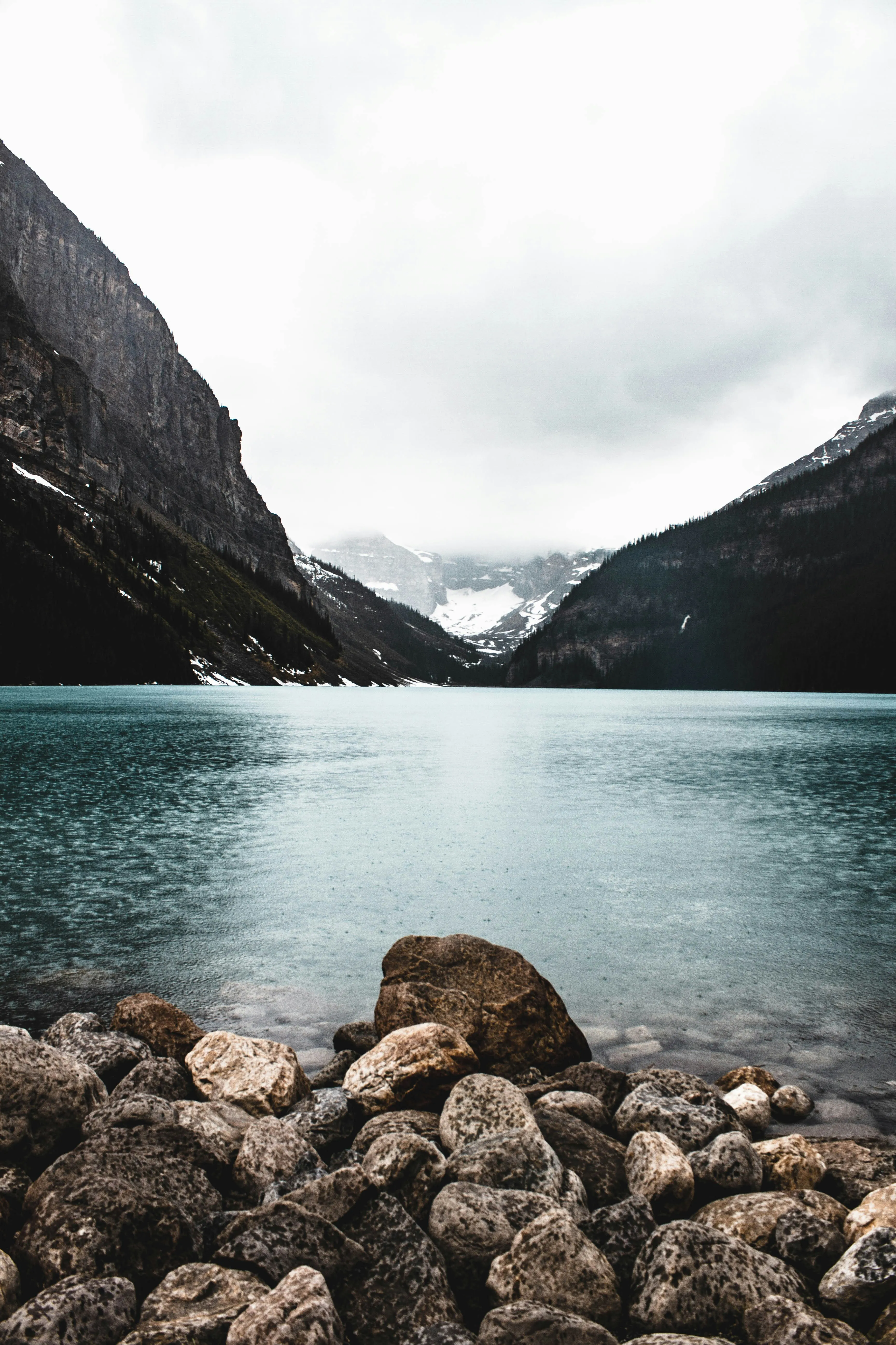 Calm Lake Between Mountains Under Cloudy Sky 4K Image