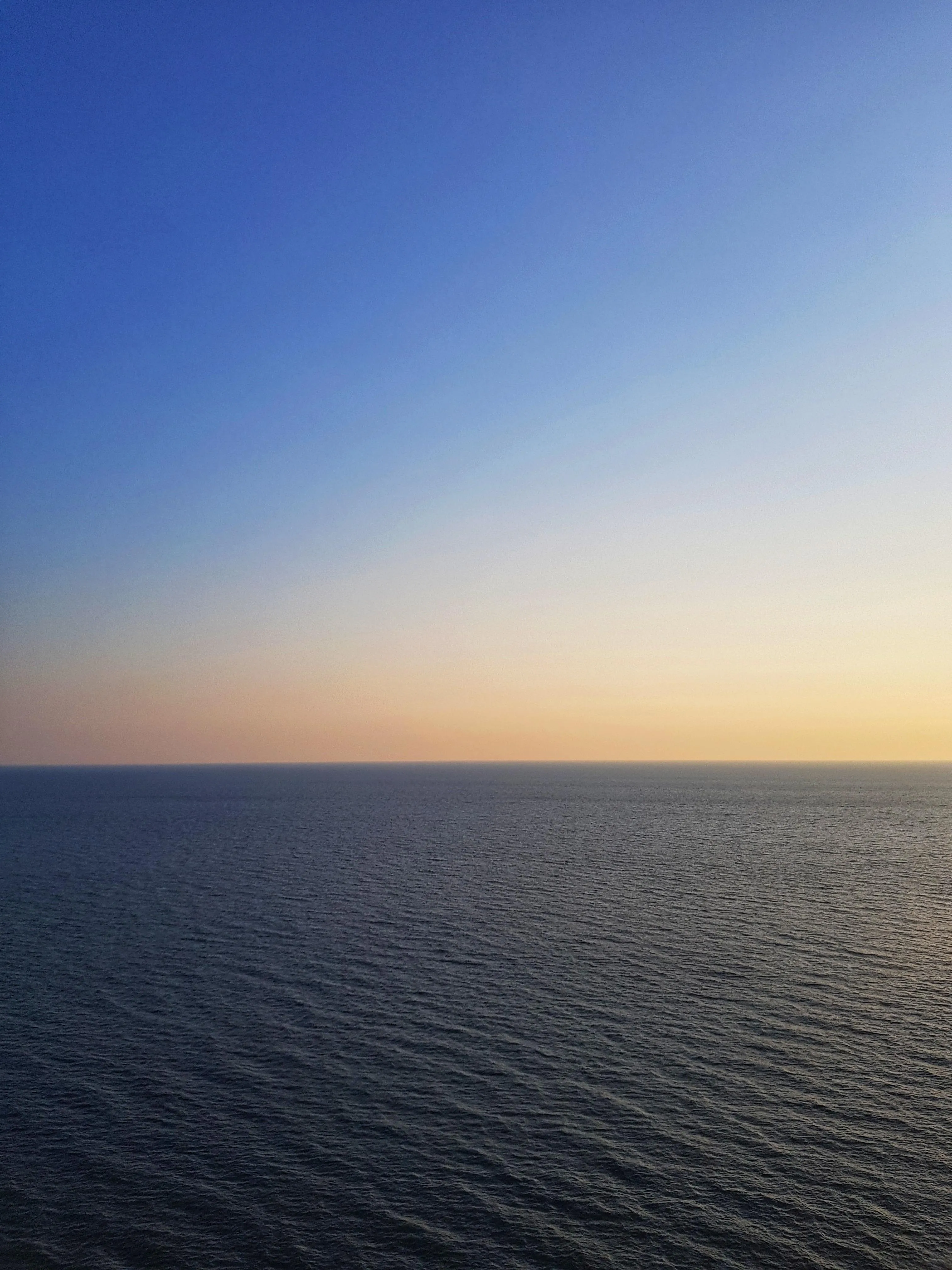 Calm Ocean Horizon with Clear Sky During Sunset Or Sunrise