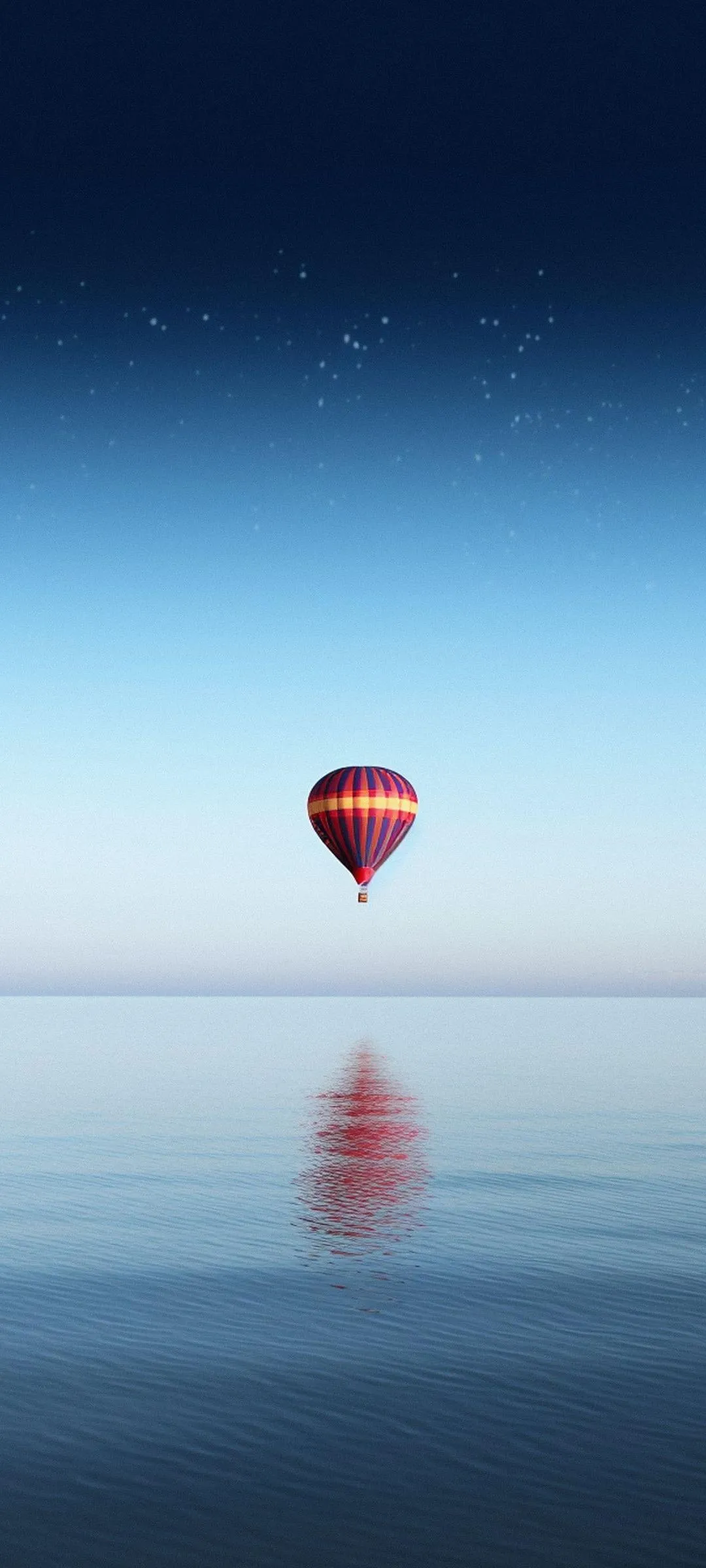 Calm Ocean Scene with Red Hot Air Balloon Reflected