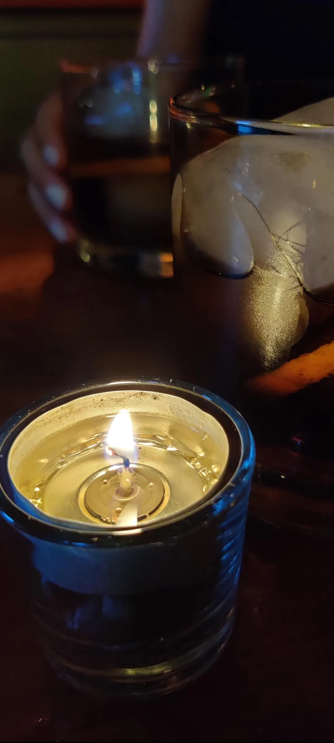 Candle Burning on Wooden Table in Cozy Warm Light Wallpaper