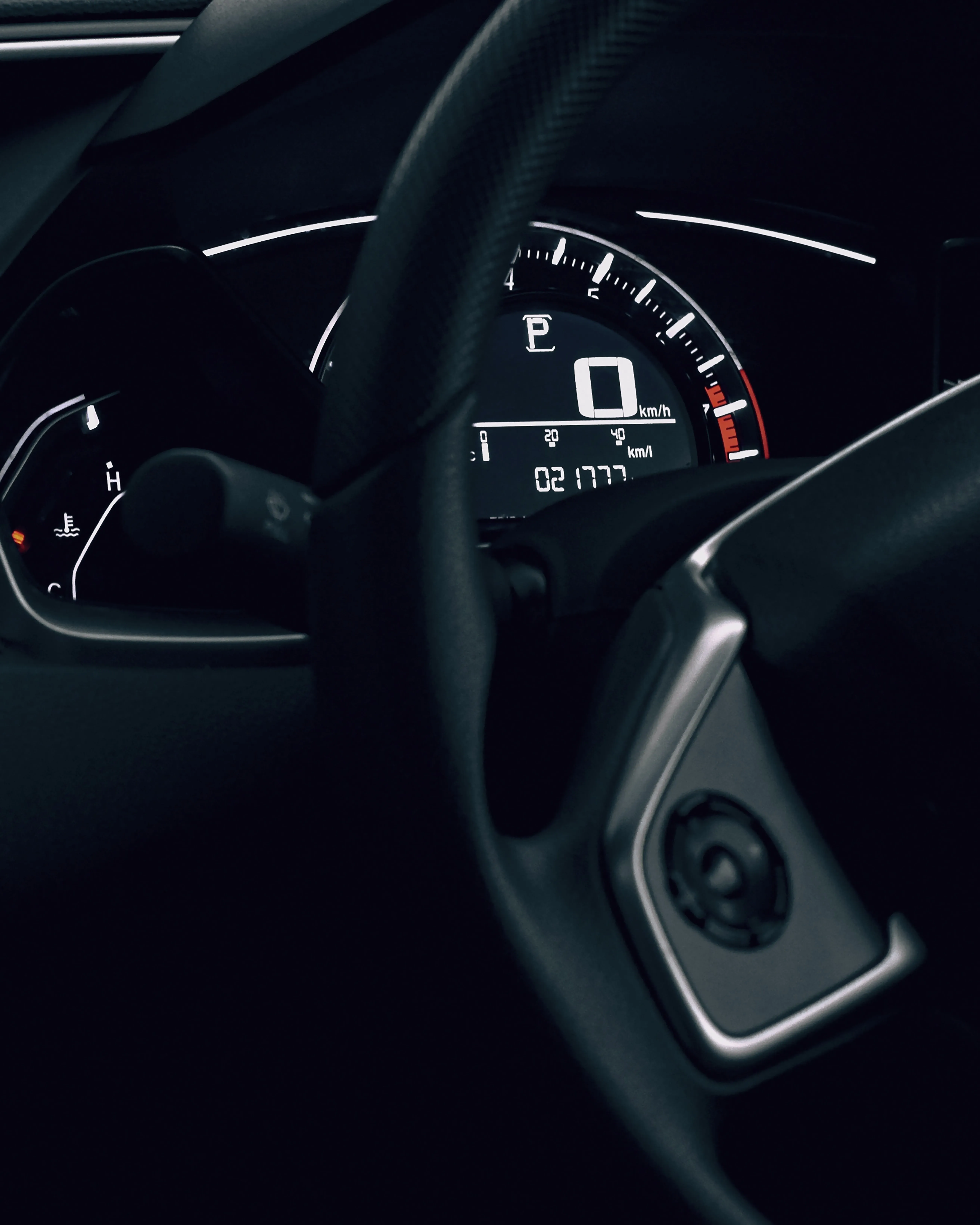 Car Dashboard Showing Speed and Black Steering Wheel