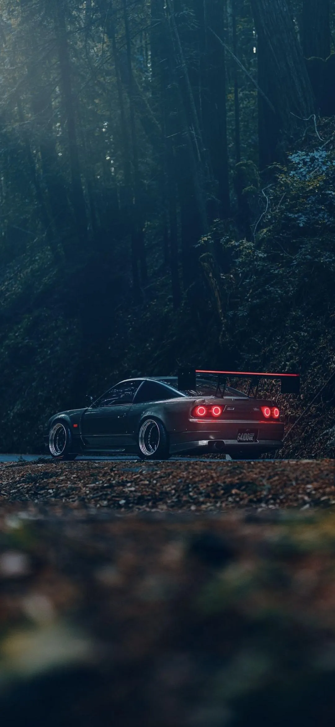 Car Driving in Foggy Forest Road Evening Scene Wallpaper