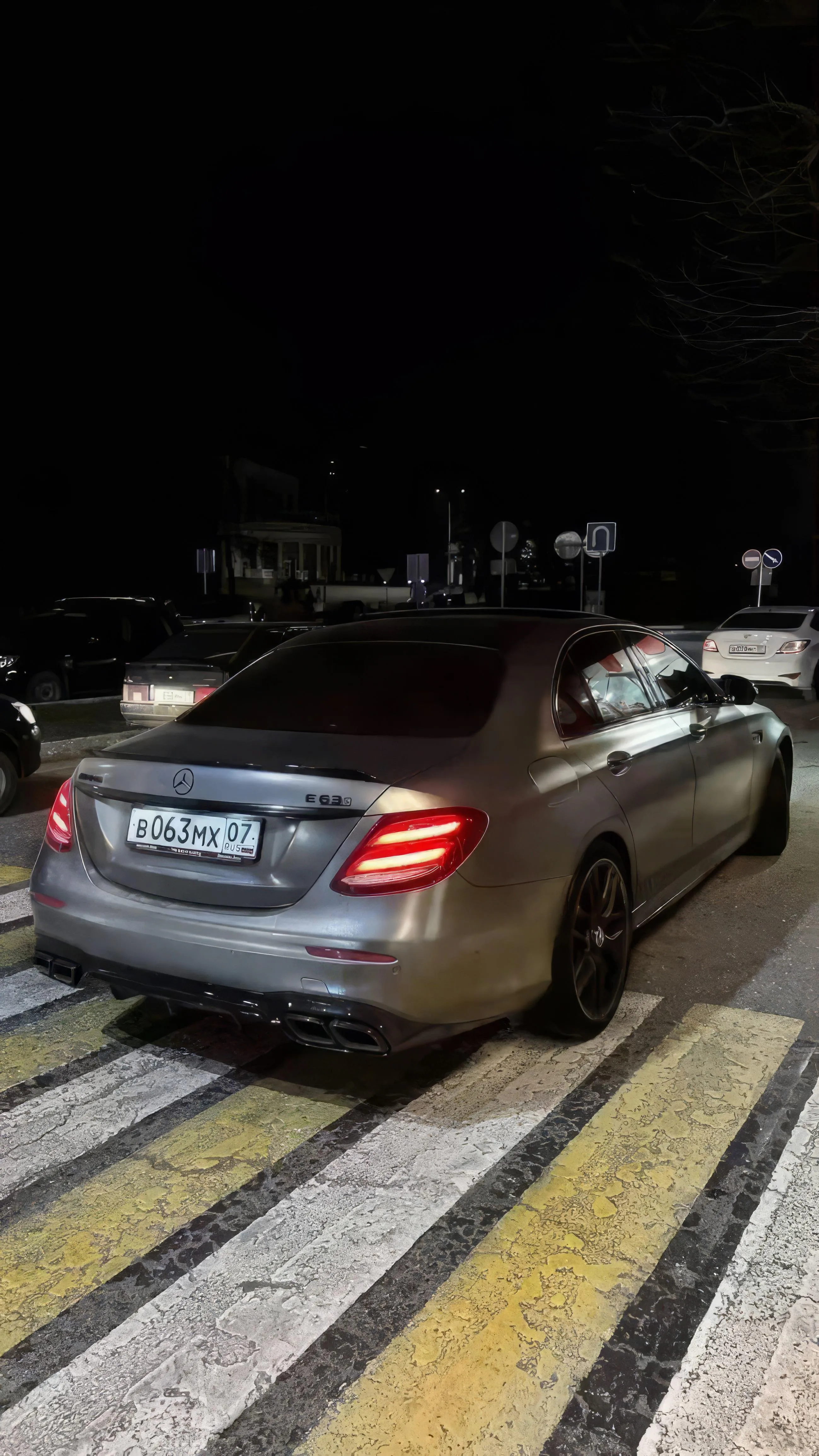 Car Parked at Night on City Street with a Yellow Crosswalk