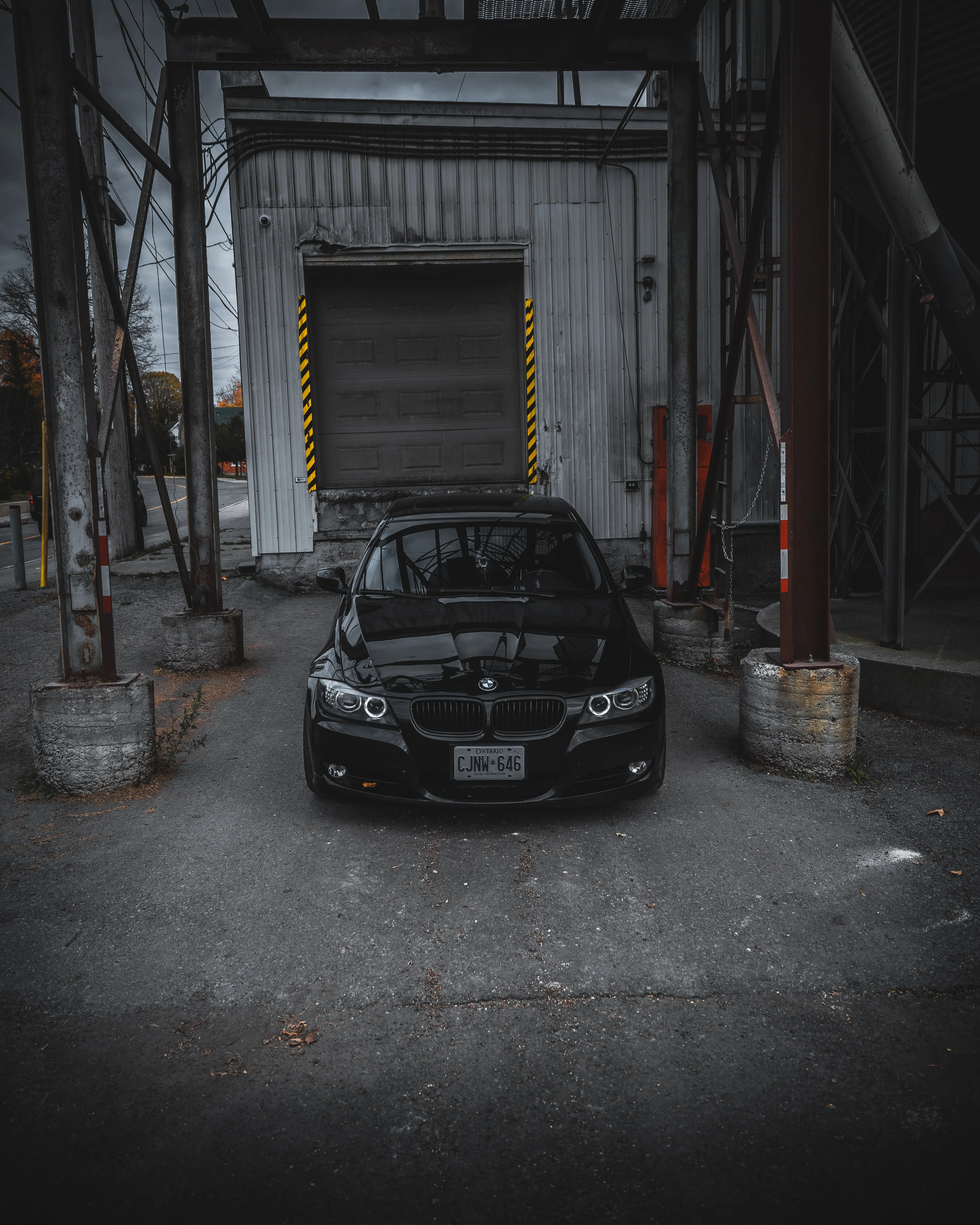 Classic Black Car in Industrial Garage Setting Wallpaper