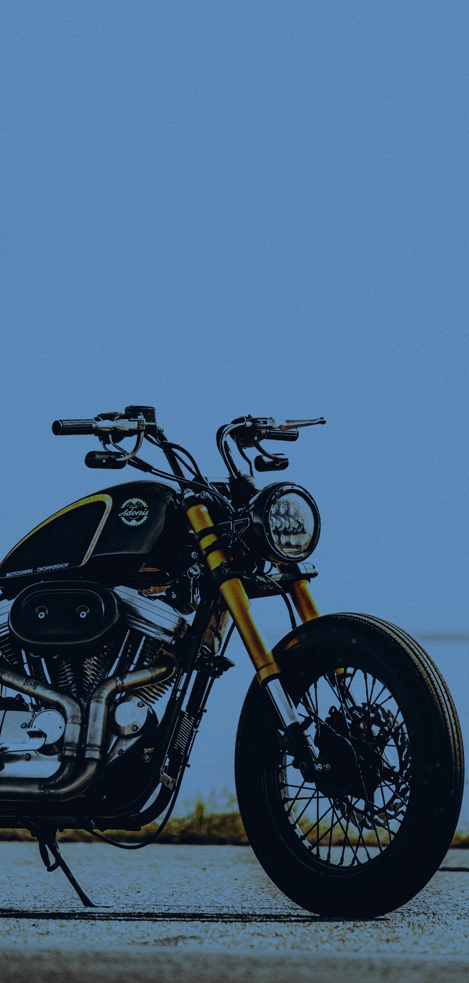 Classic Black Motorcycle on Blue Background Wallpaper