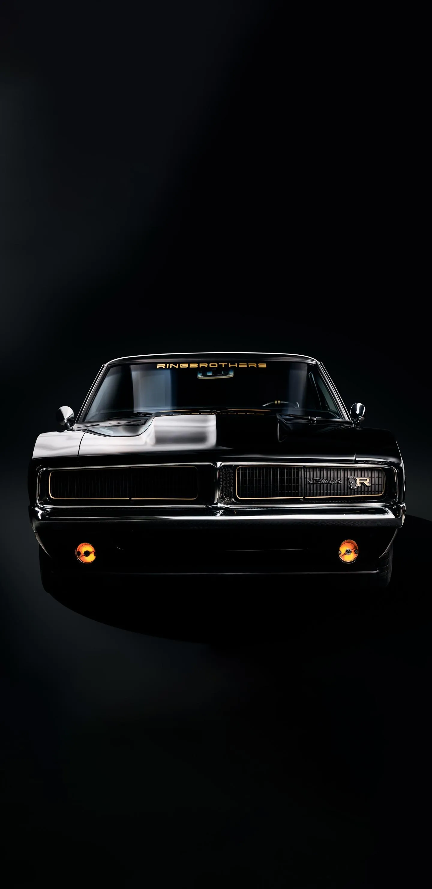 Classic Car Driving at Night with Soft Light Glow Wallpaper