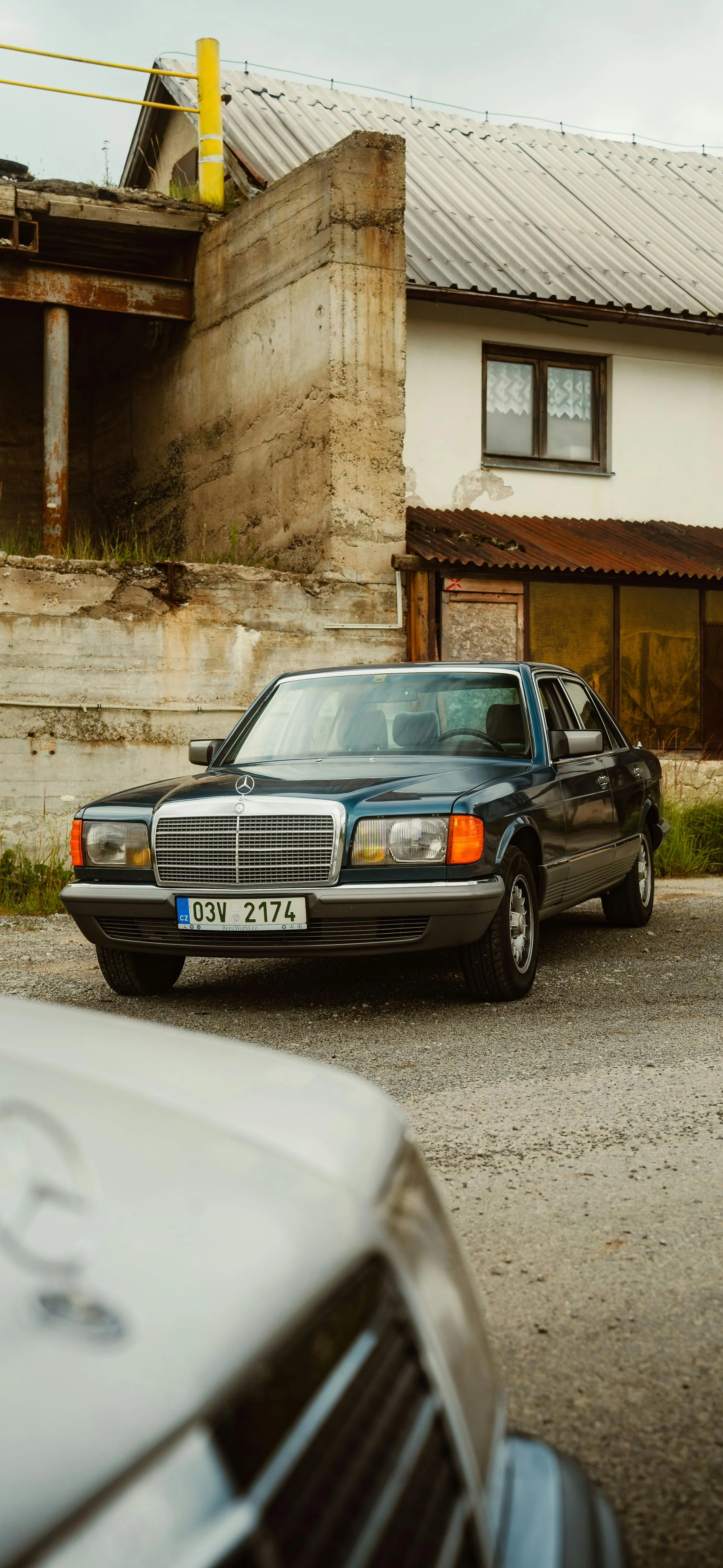 Classic Car Parked on Old Street in Rustic Village Setting
