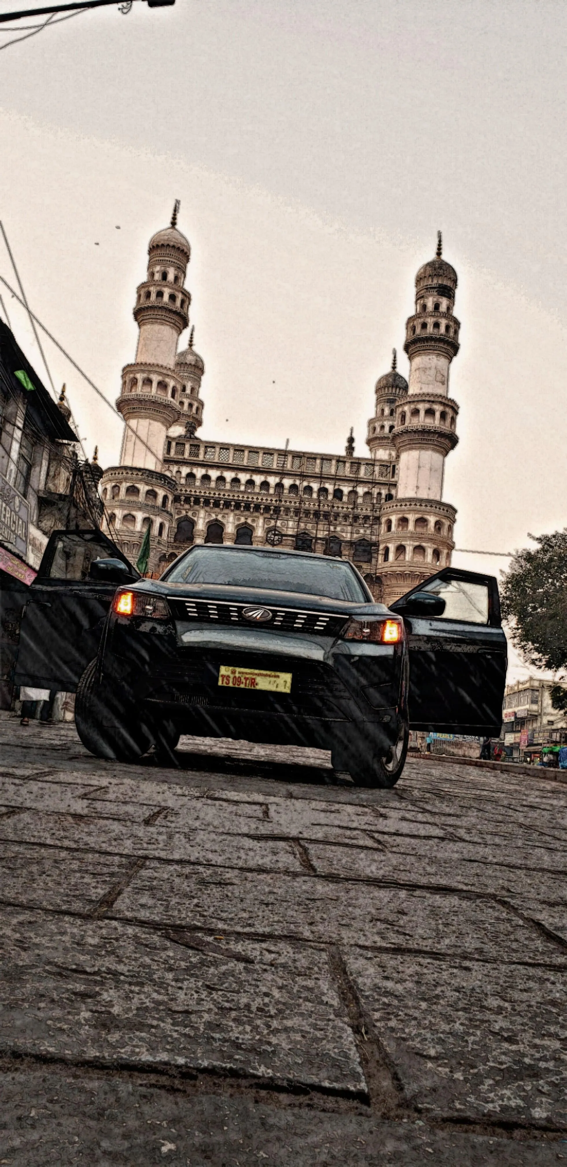 Classic City Car Driving on a Rough Old Stone Roadway