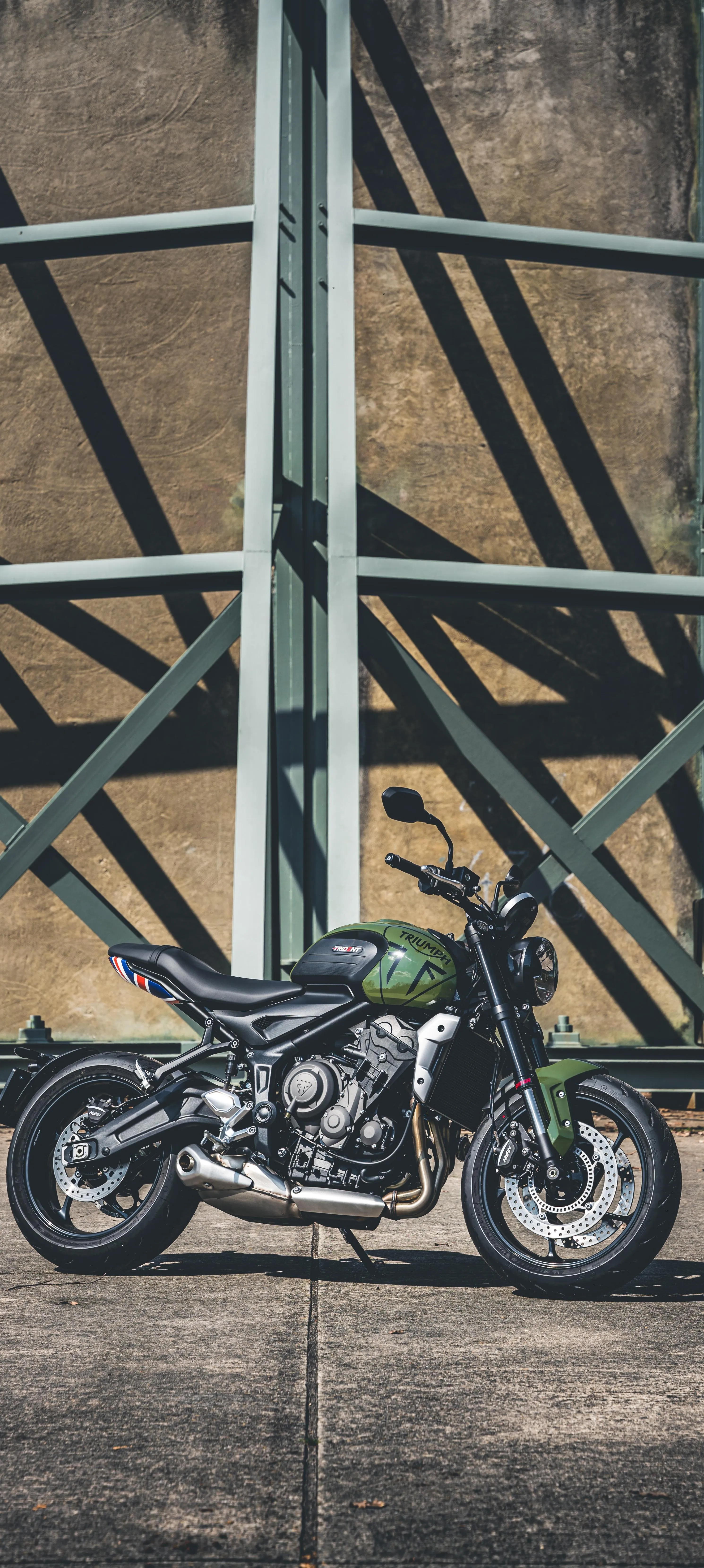 Classic Motorcycle Parked Next To Industrial Structure