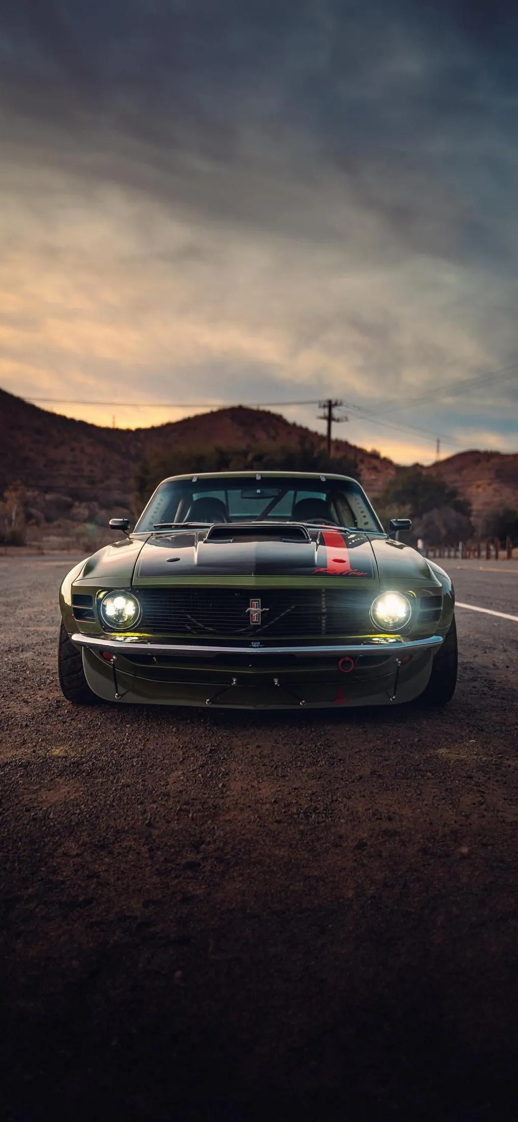 Classic Muscle Car Front View On Road At Sunset Wallpaper