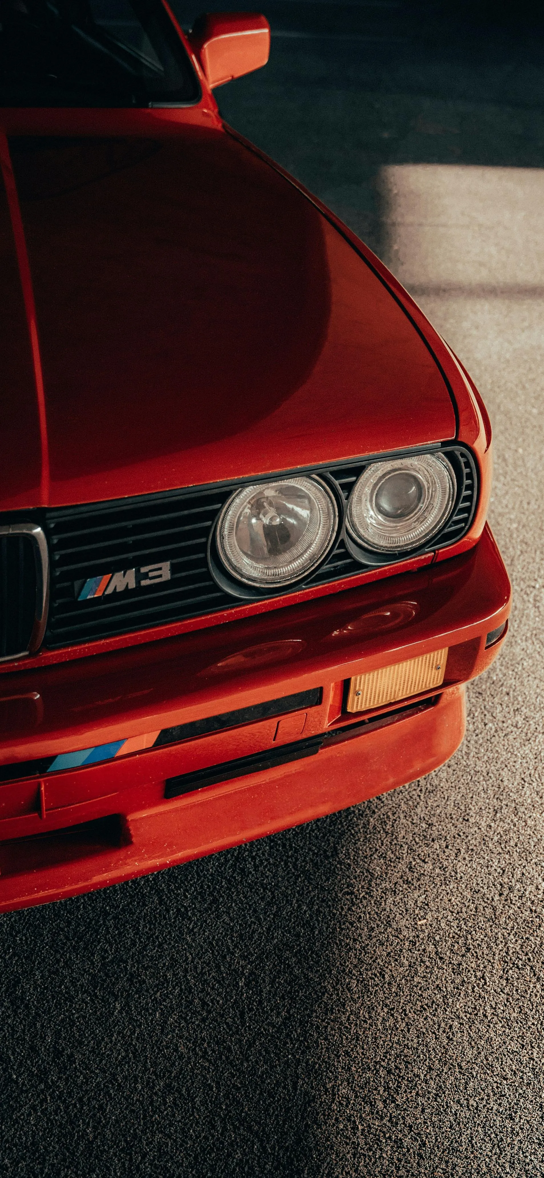 Classic Red Car Front Closeup Showing Vintage Headlights