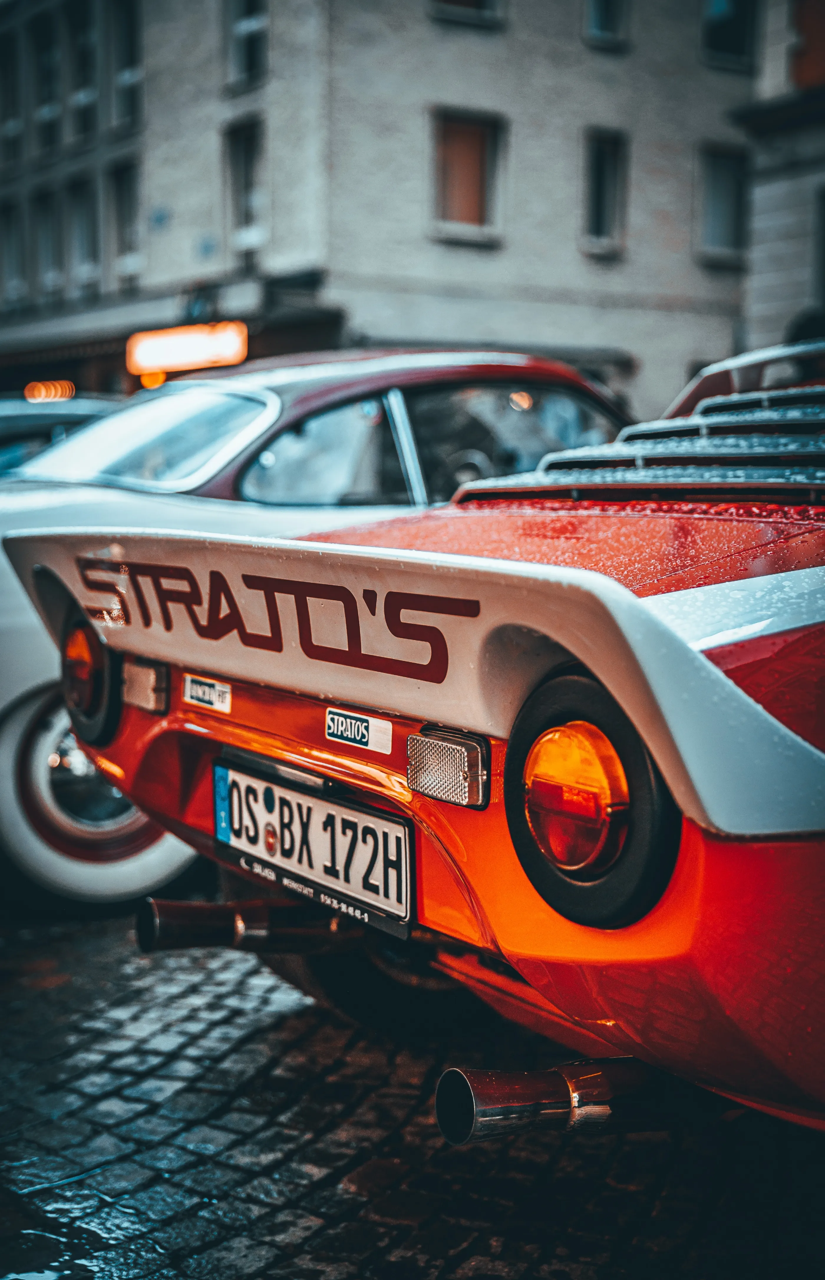 Classic Sports Car Parked on Historic City Street Wallpaper