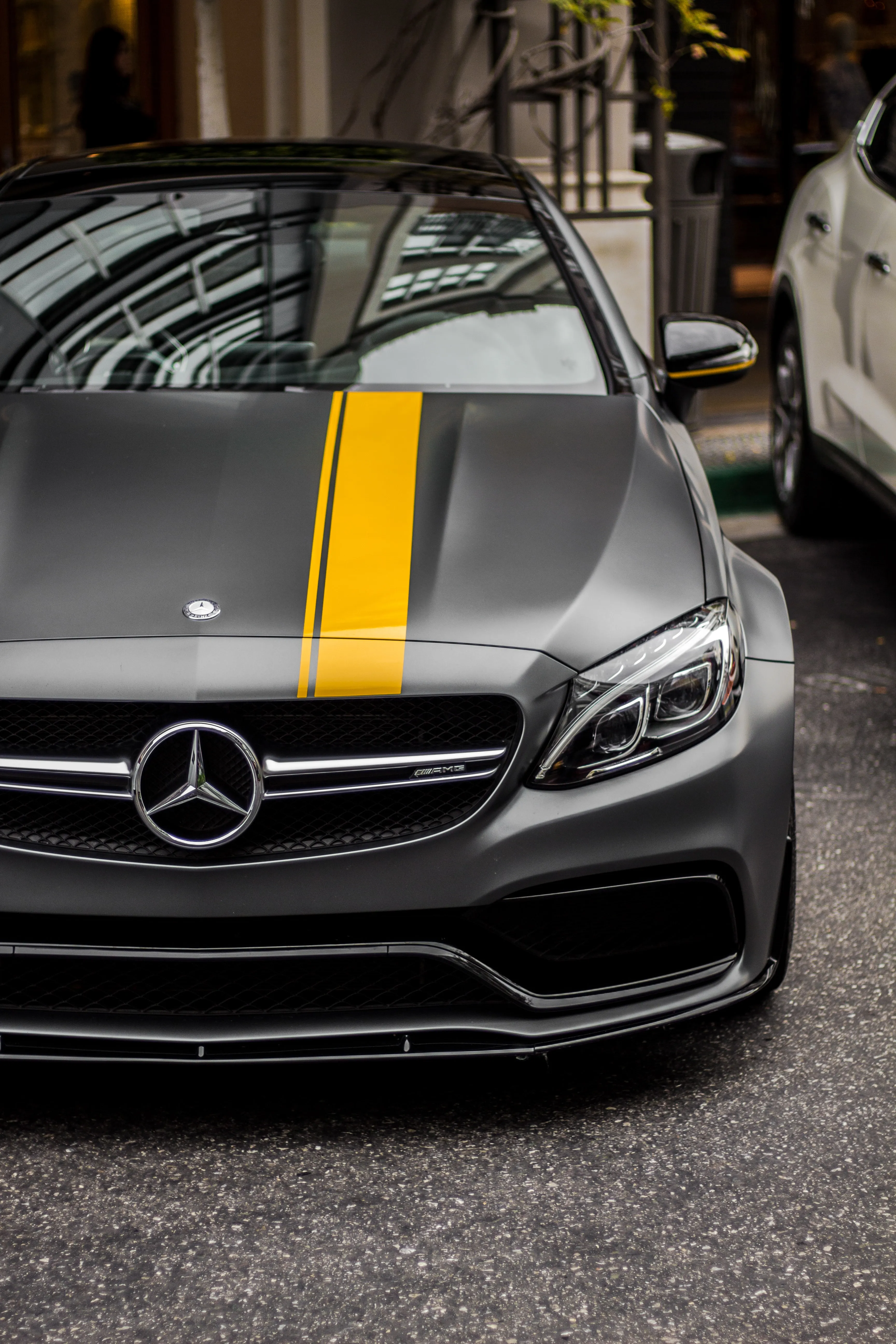 Close Up of Black Sports Car with Yellow Stripe Image
