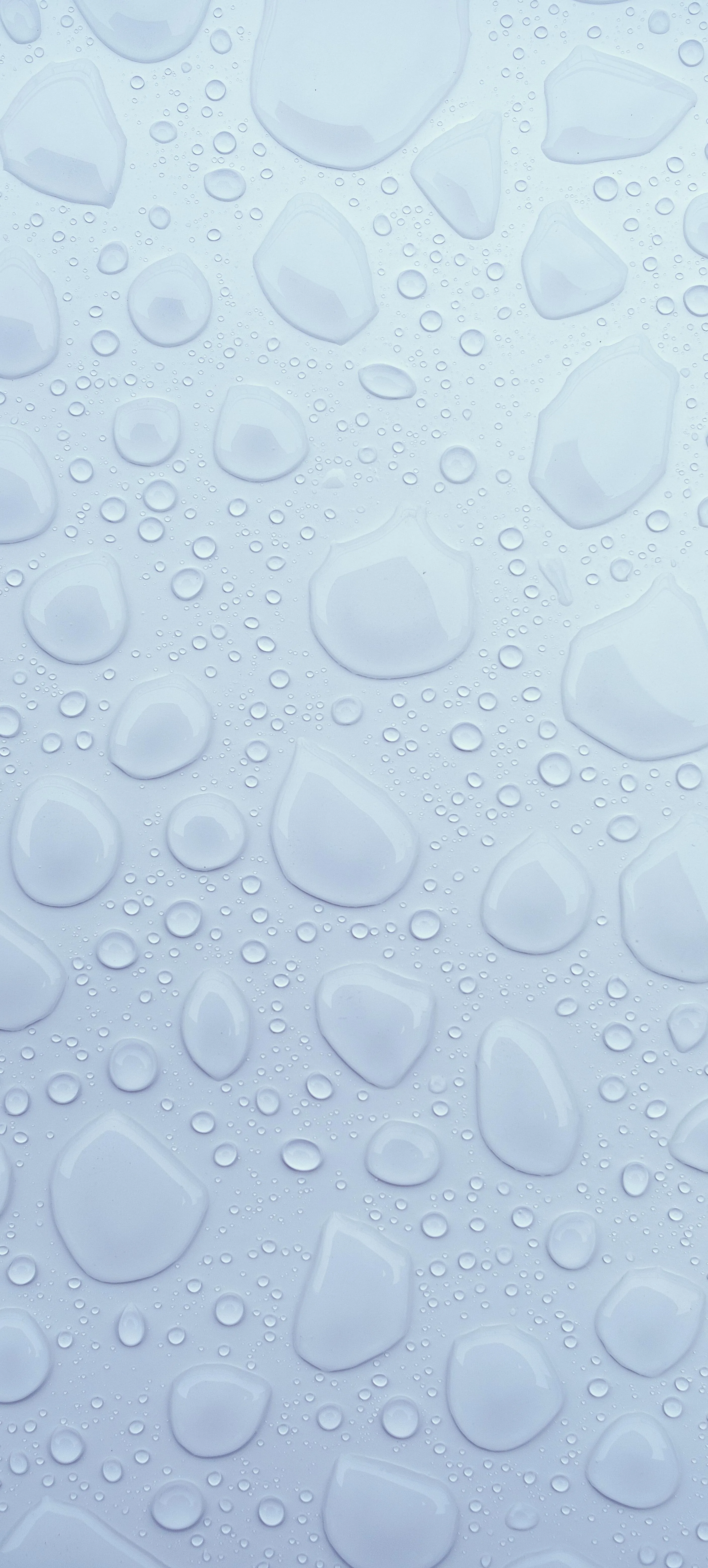 Close Up of Water Droplets on a Light Blue Surface Wallpaper
