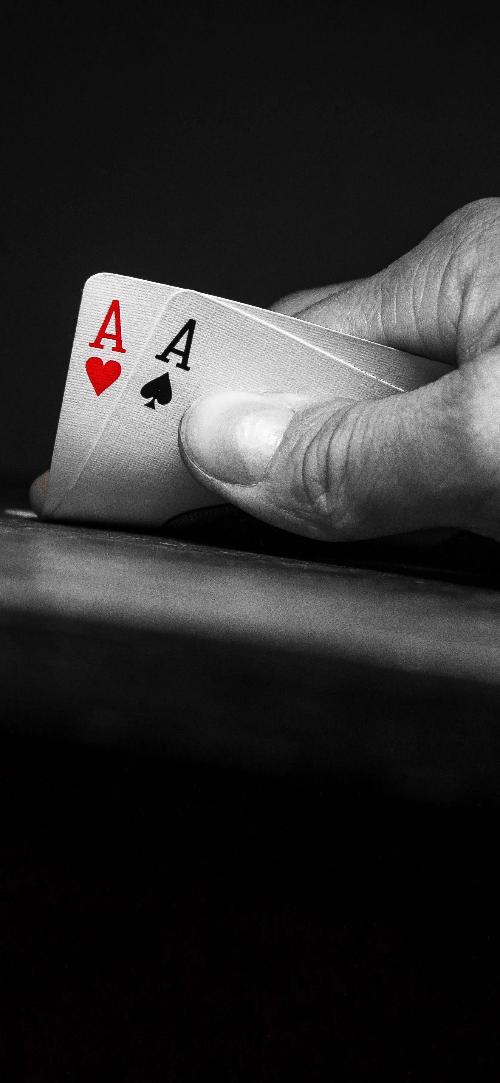 Closeup of Hand Holding Ace Card in Poker Game Wallpaper