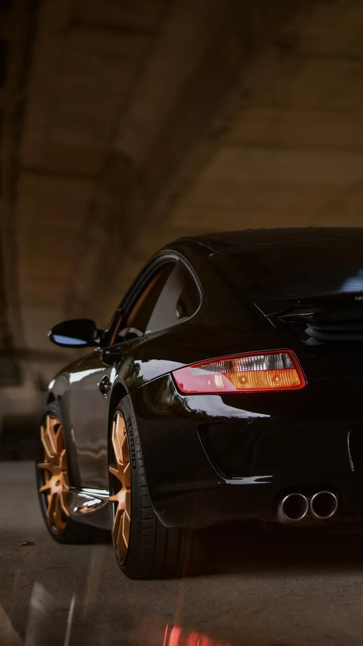Closeup of Sleek Sports Car Under Bridge Urban Wallpaper