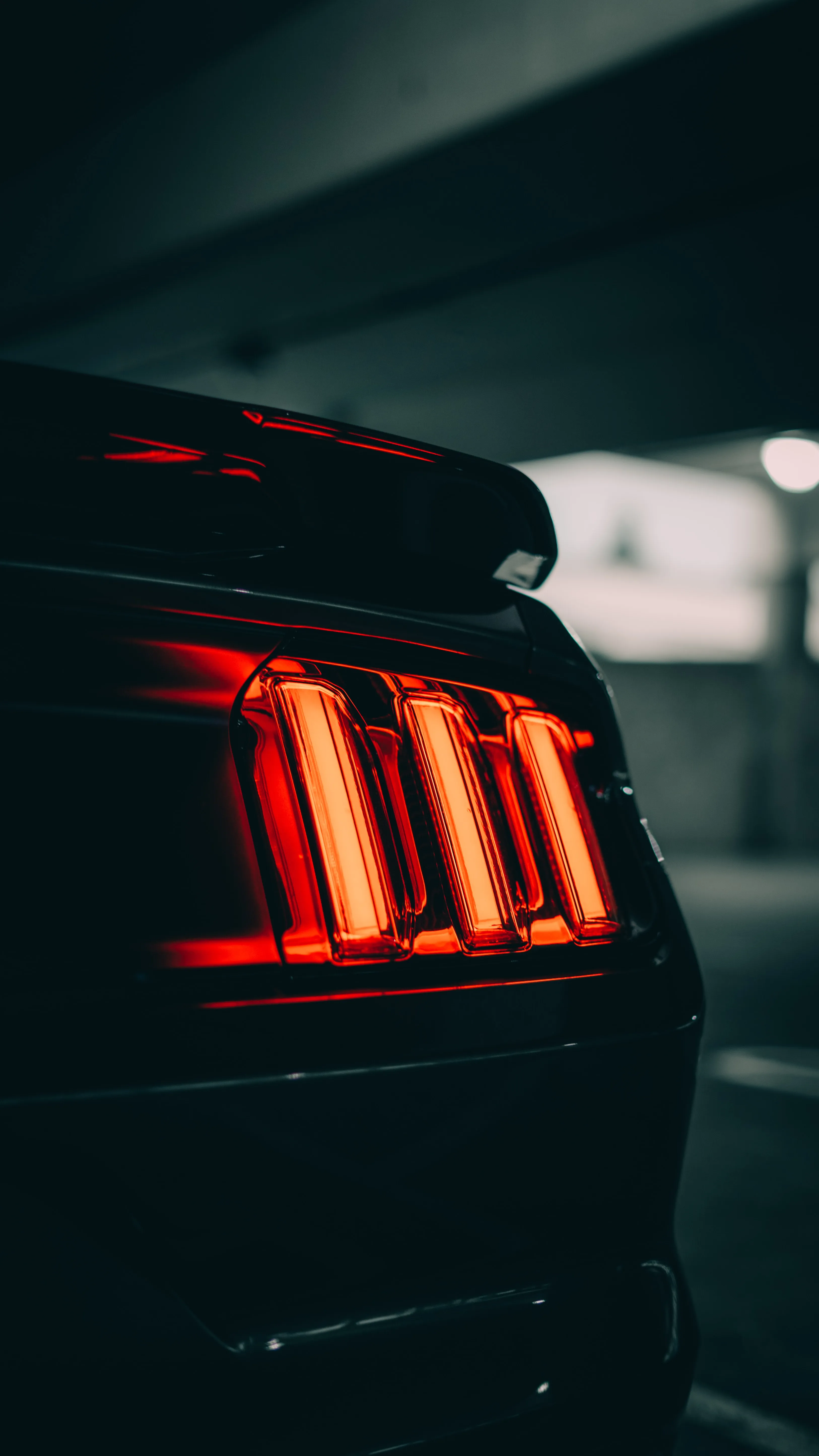 Closeup Rear Car Lights Glowing in Dark Street Wallpaper