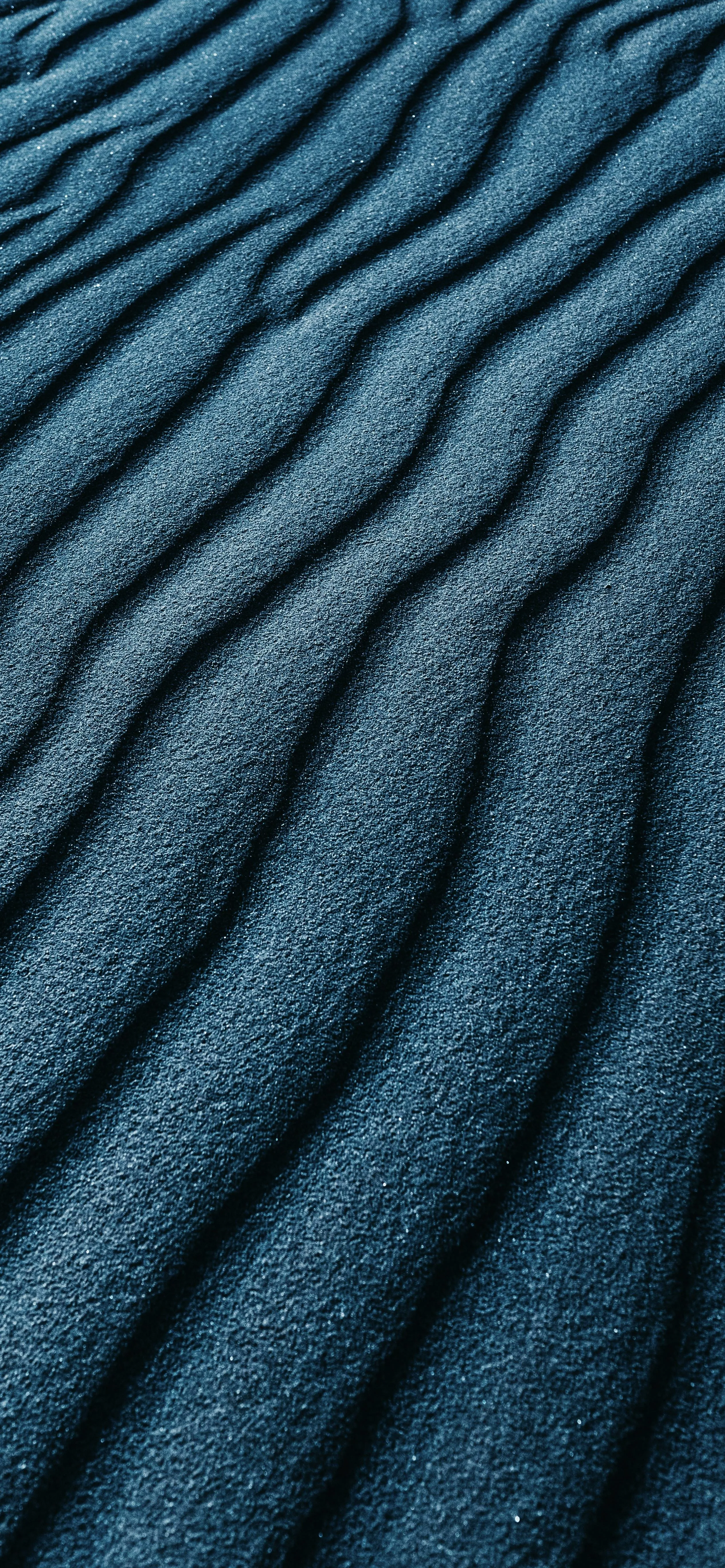 Closeup Texture of Blue Sand Dune Patterns Wallpaper