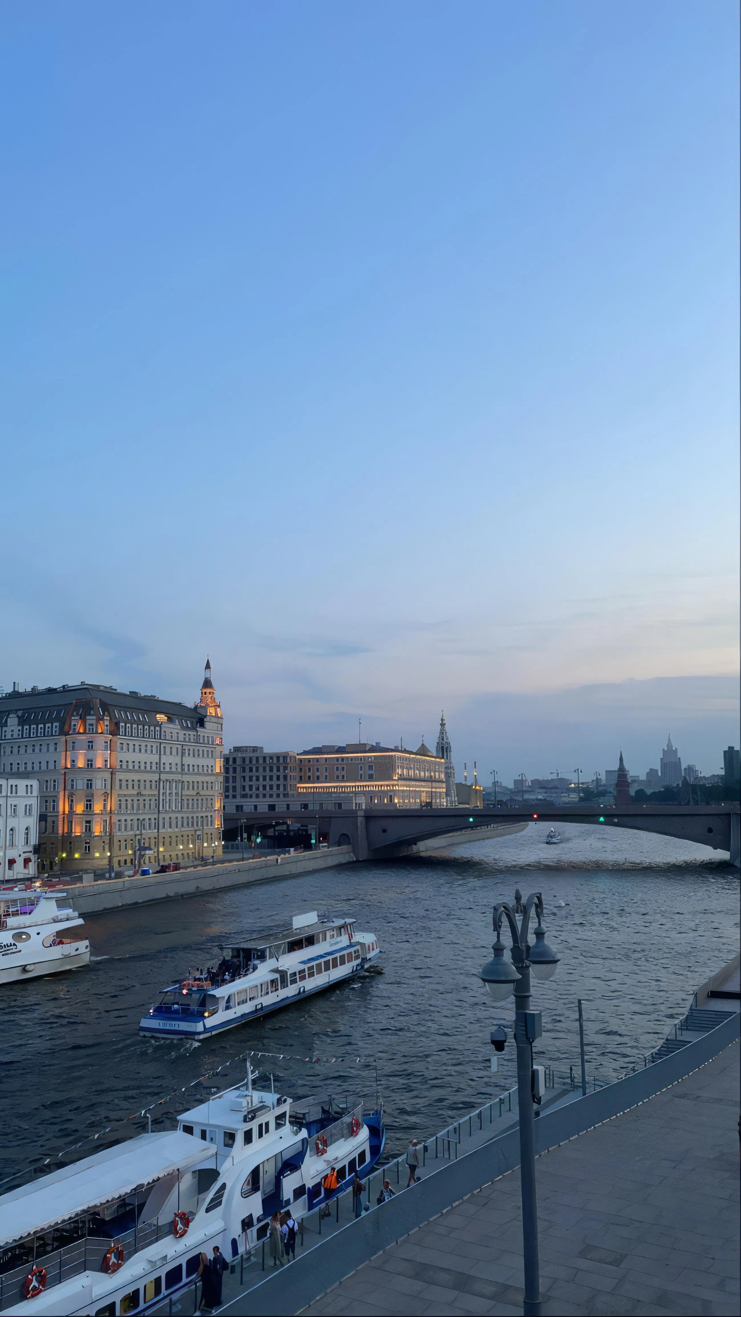 Coastal City with Boats and Sunset Reflections Wallpaper