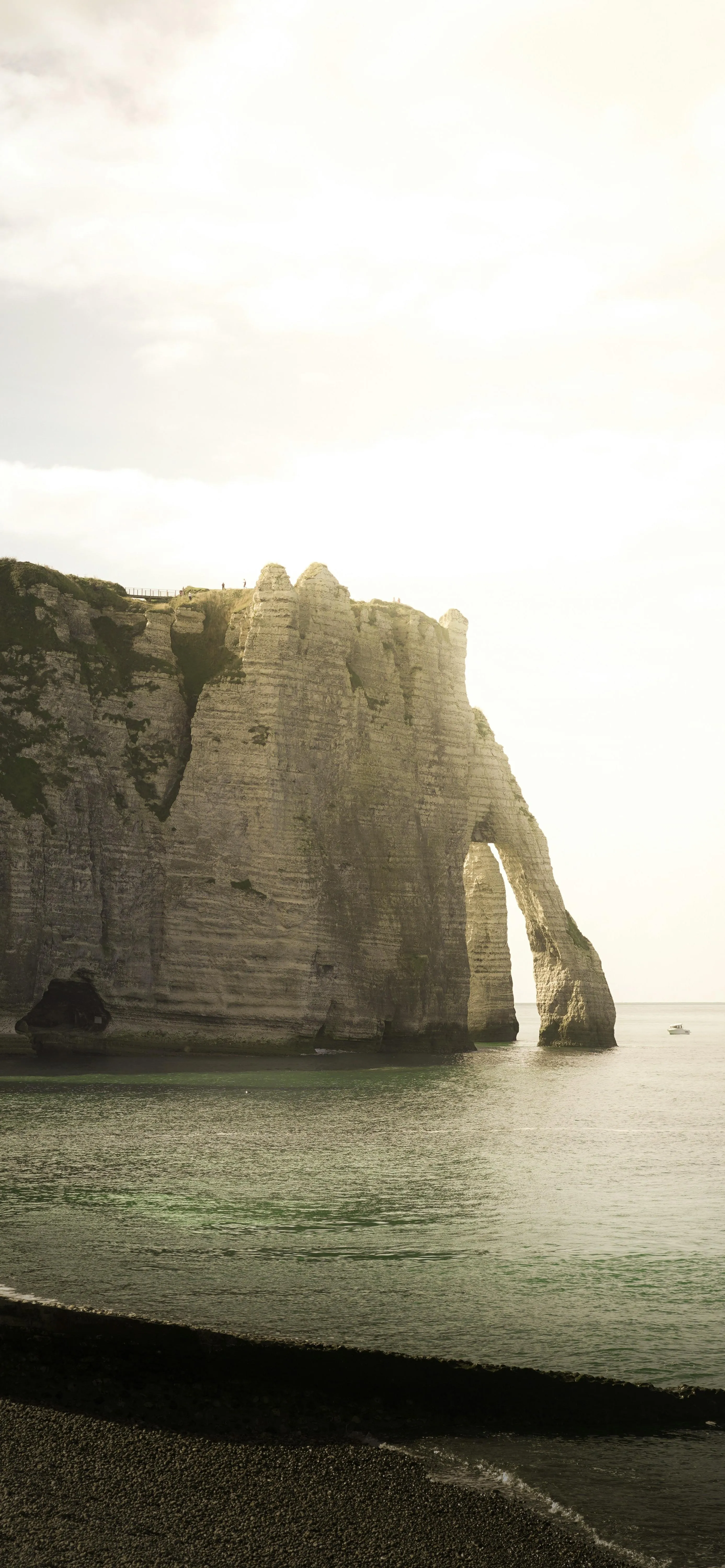 Coastal Cliffs and Calm Sea Under Warm Sunset Light