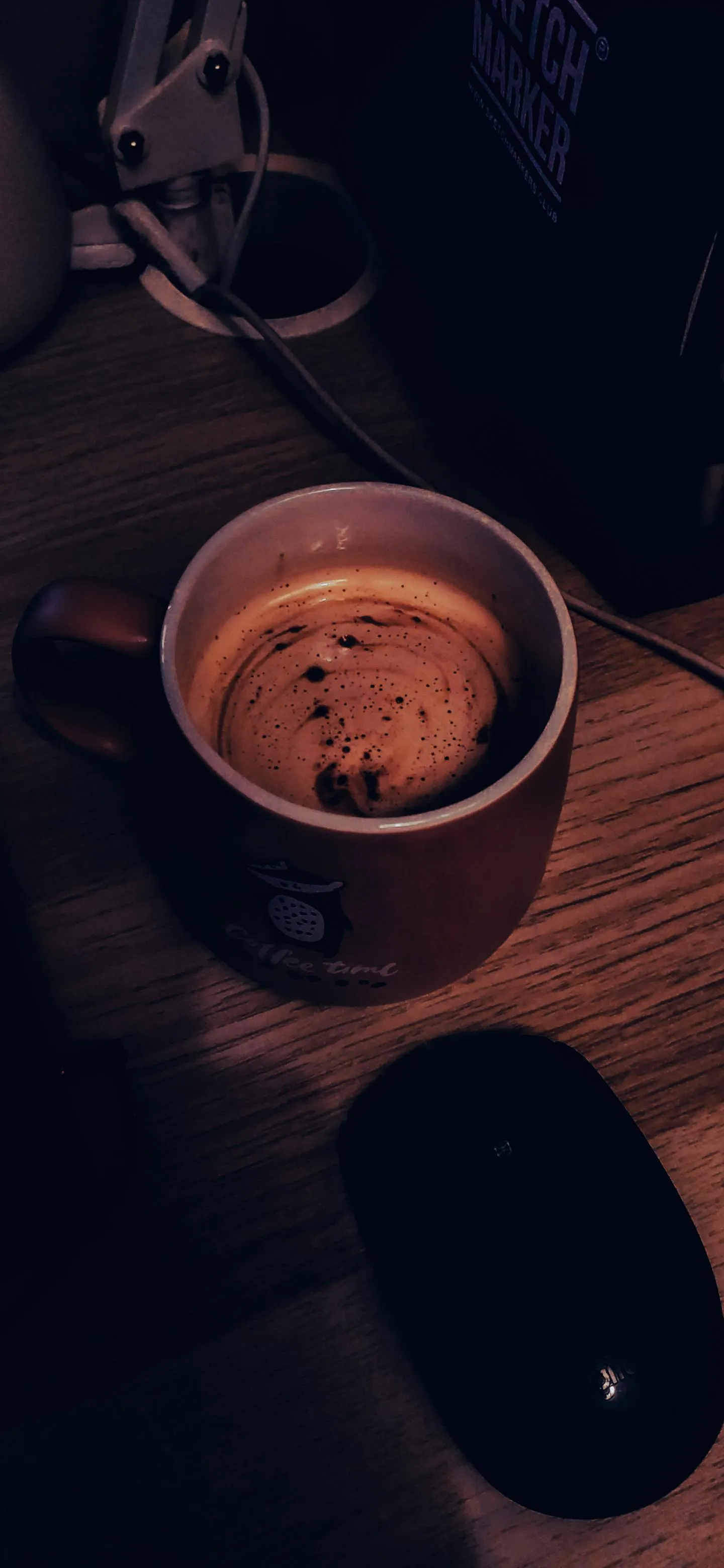 Coffee and Mouse Setup with Cozy Lighting for Relaxing Mood