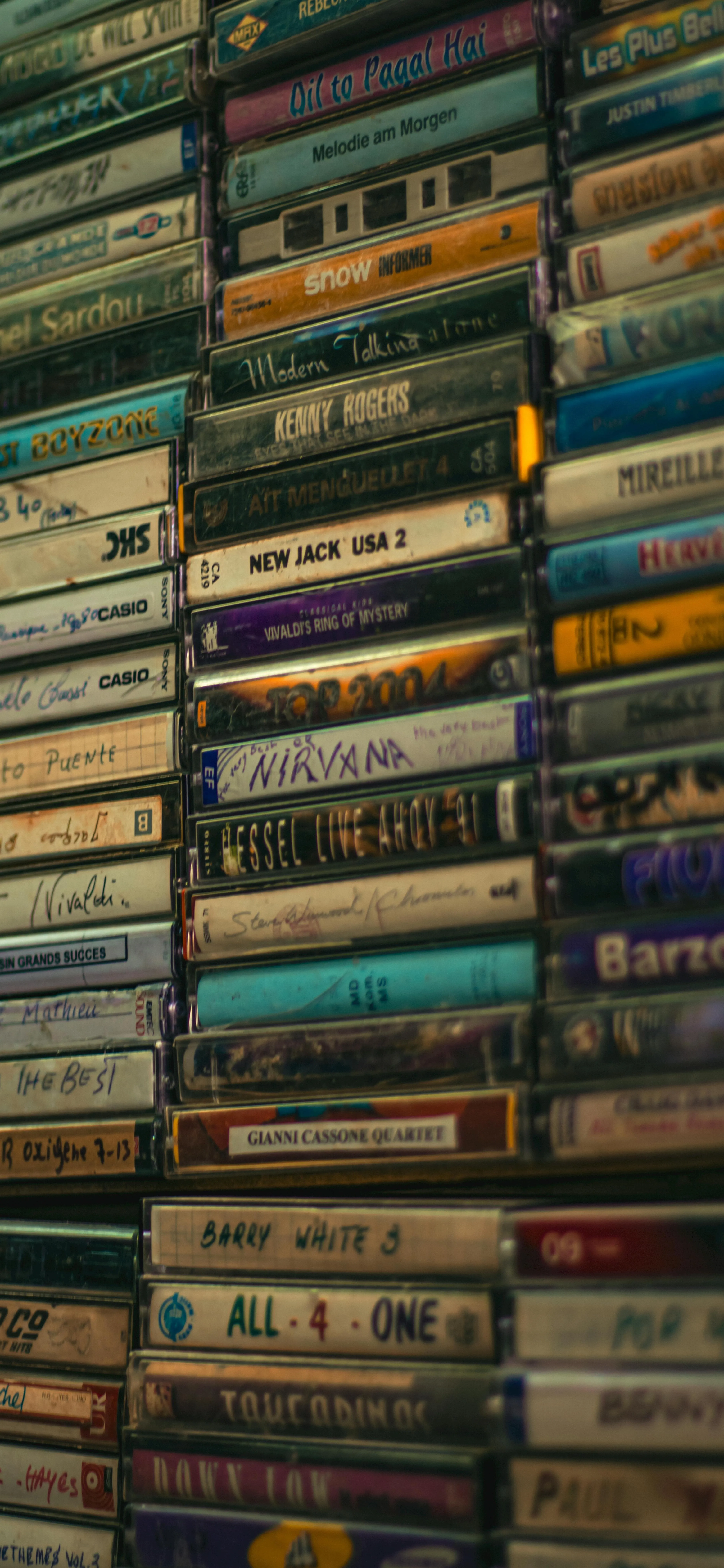 Collection of Old Vintage Books Stacked on Shelf Wallpaper
