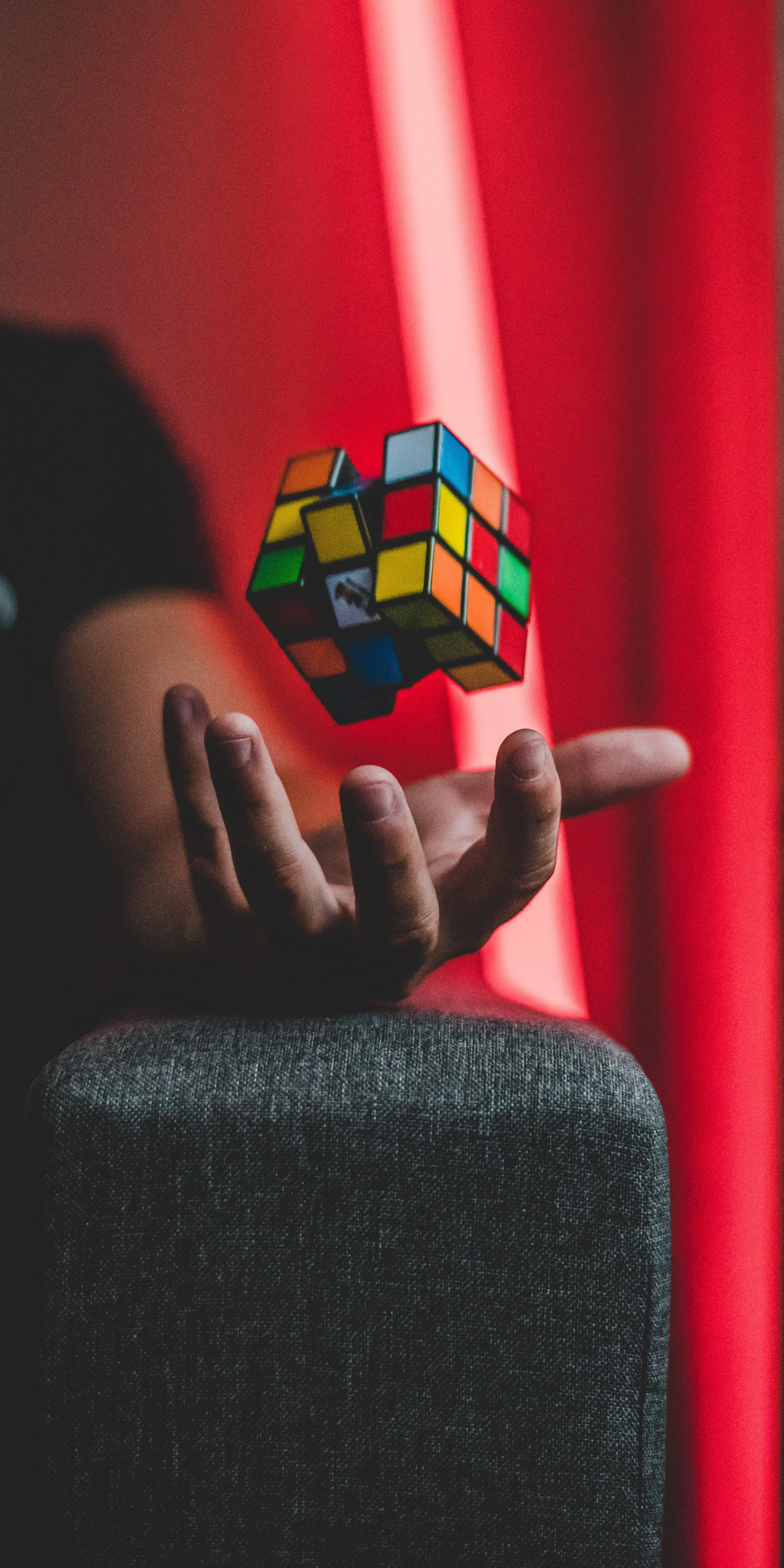 Colorful Rubiks Cube on Chair with Red Curtain Free 4K Image