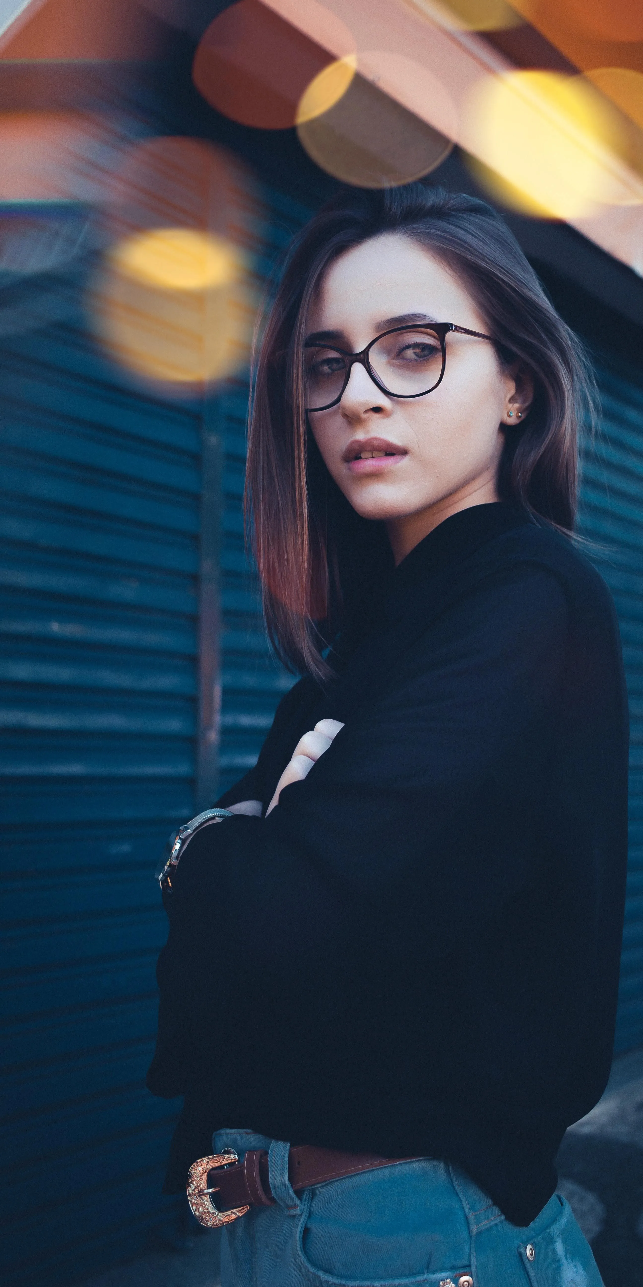 Confident Woman Posing with Blurred City Background