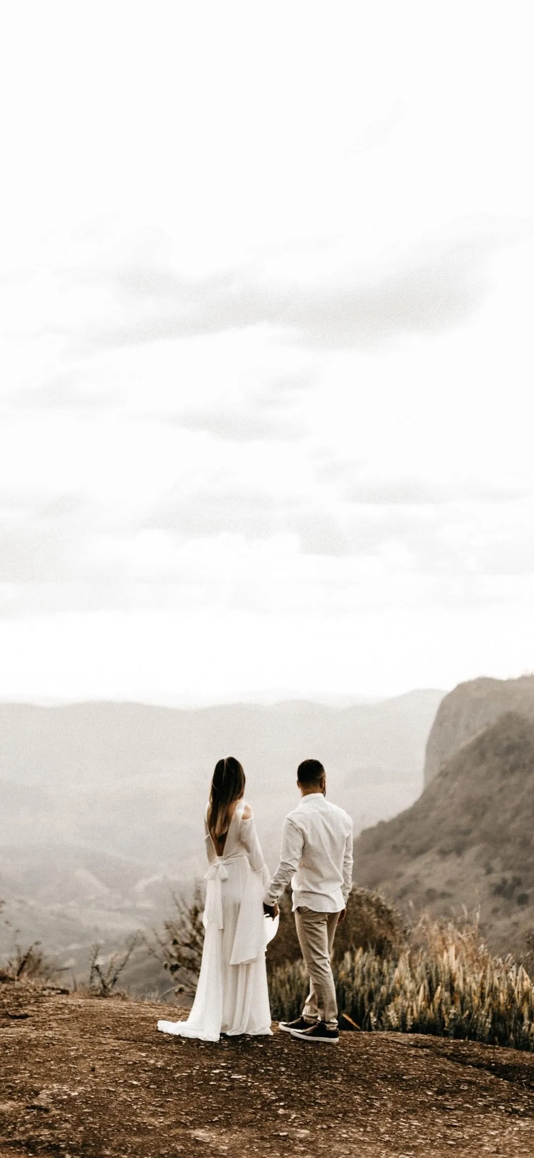 Couple Standing in Love in a Calm Foggy Landscape Wallpaper