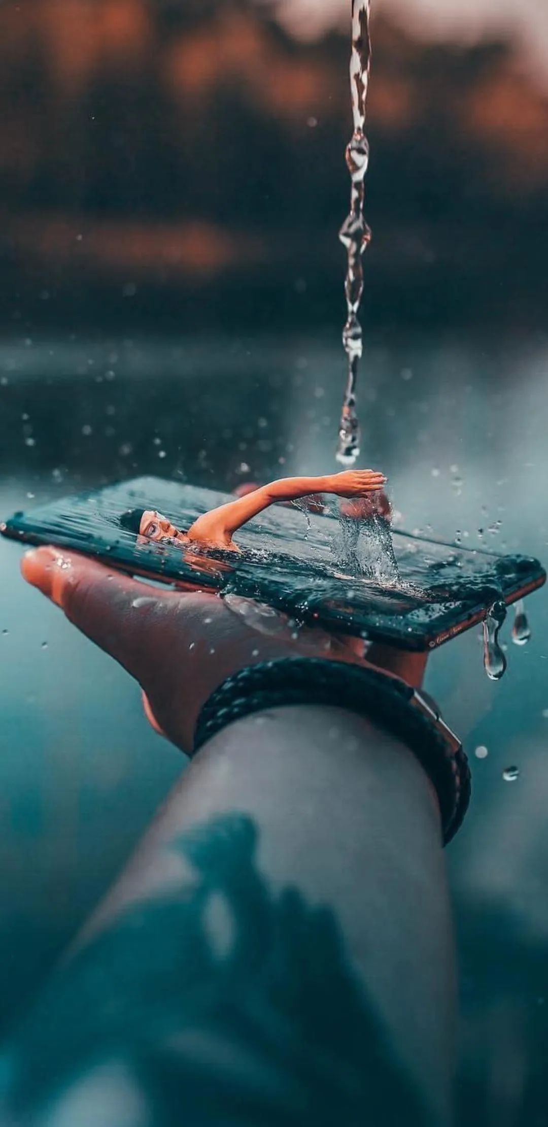 Creative Surreal Art of Swimmer Emerging from Phone