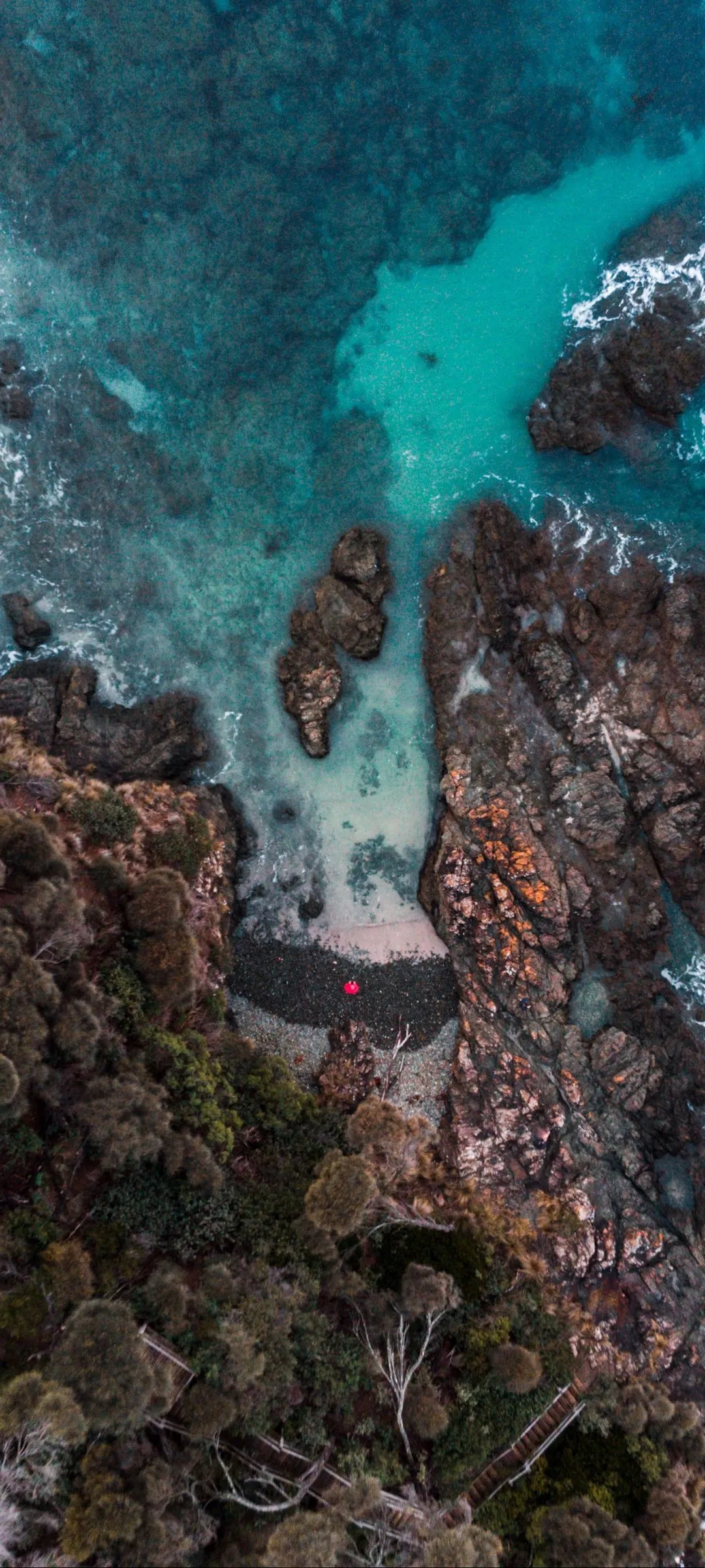 Crystal Clear Turquoise Water Over Rocky Ocean Shoreline