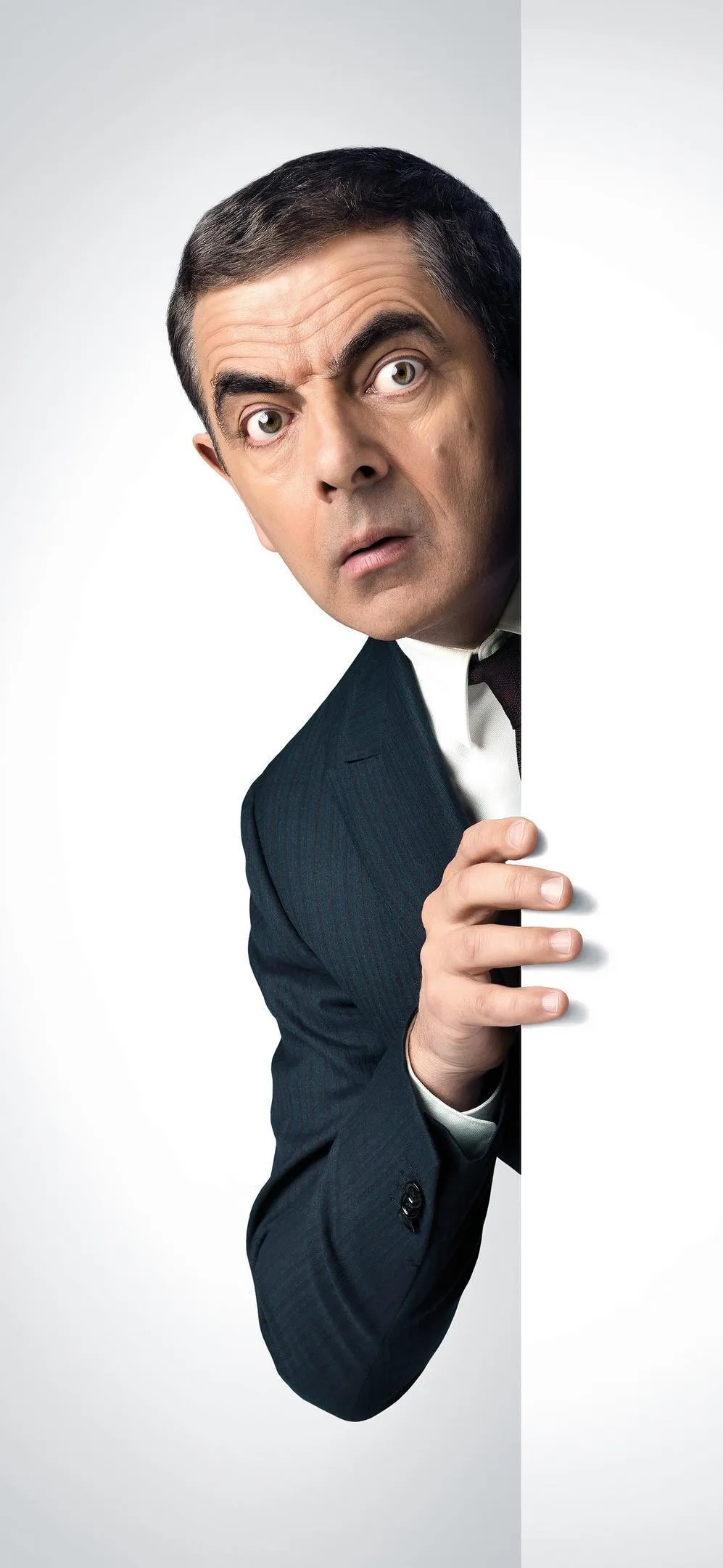 Curious Mr Bean Peeking from Wall in Formal Business Suit