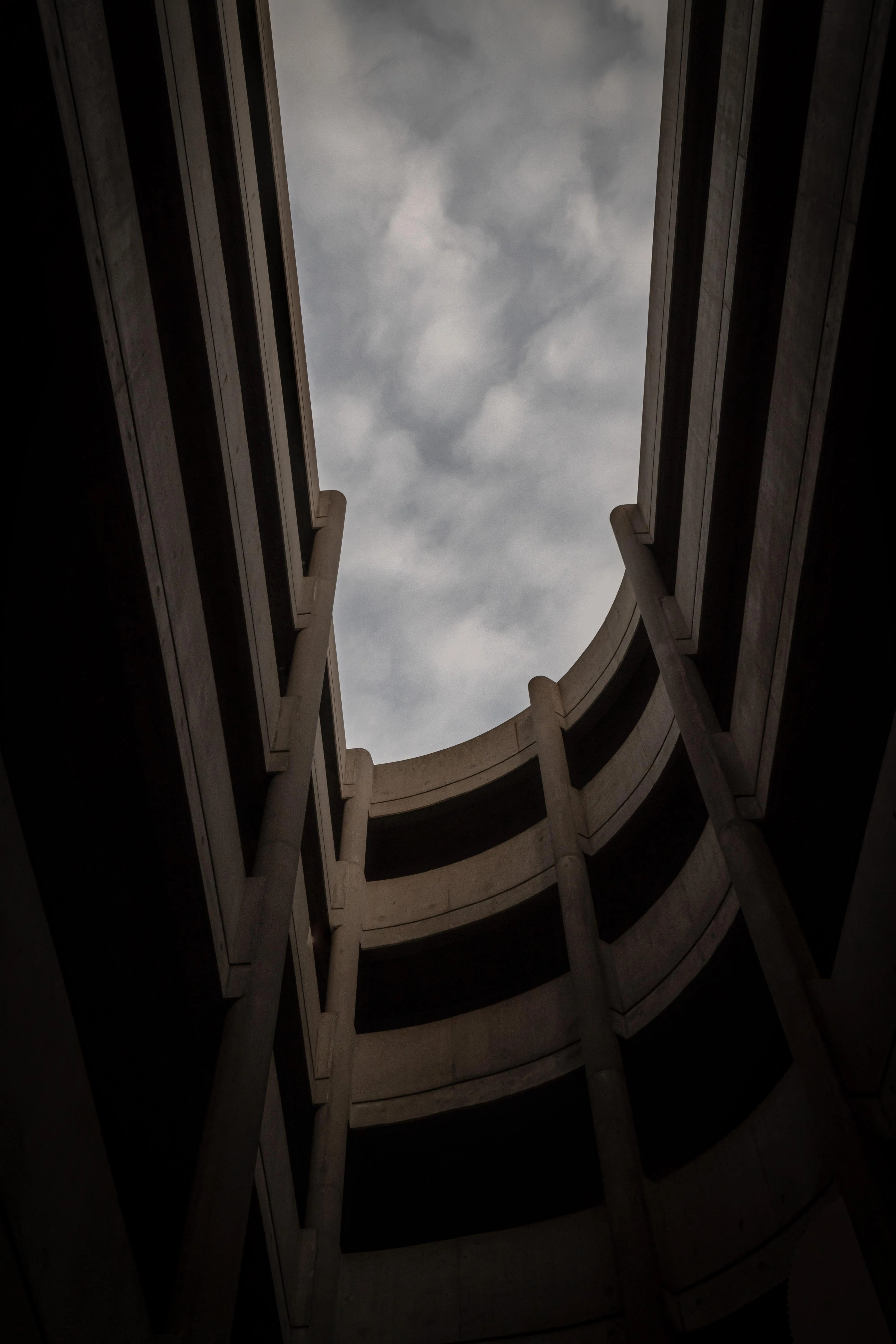 Dark and Narrow Looking Up Inside Circular Building Shaft