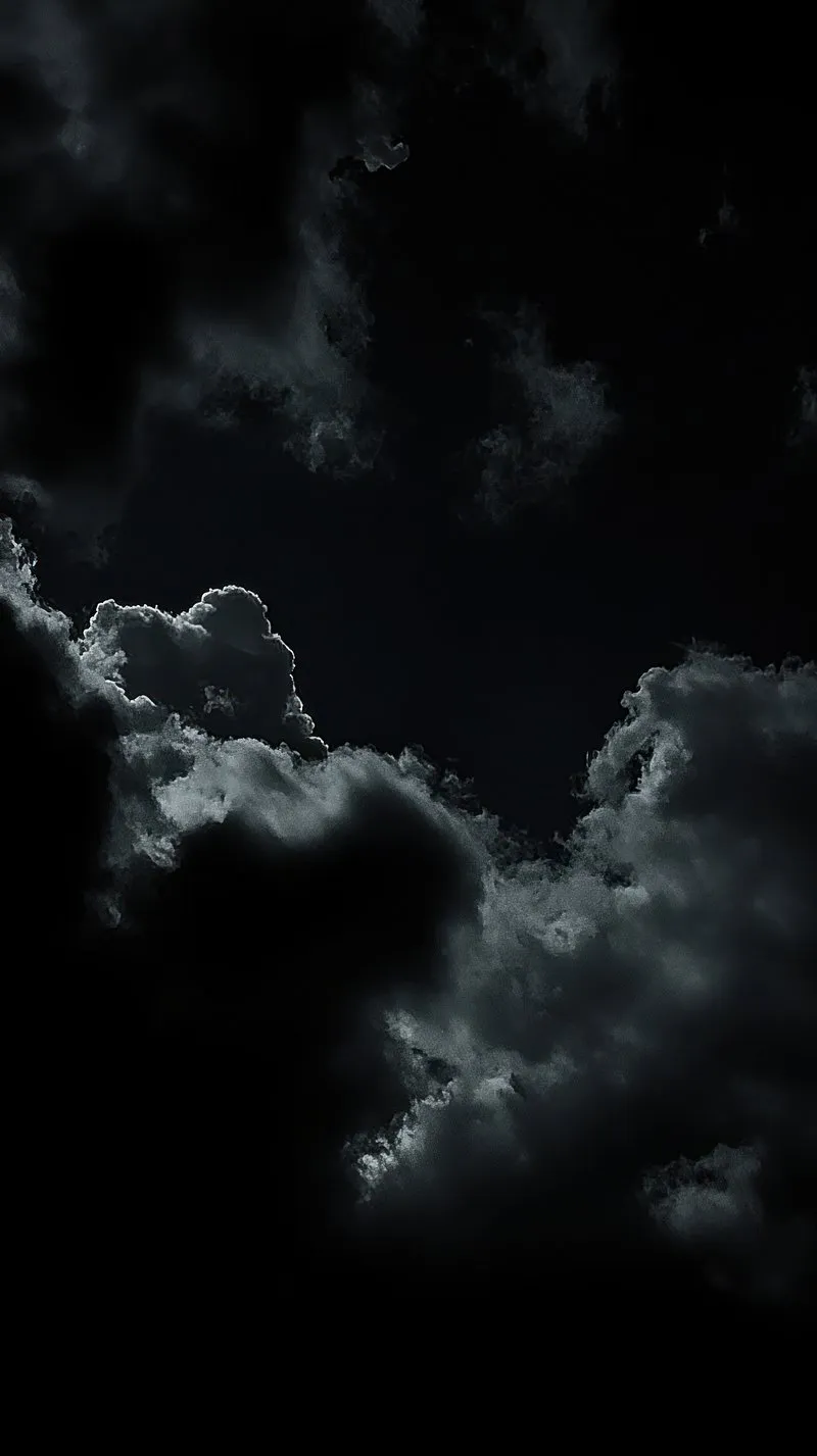 Dark Clouds Forming a Dramatic Shape in Moody Night Sky