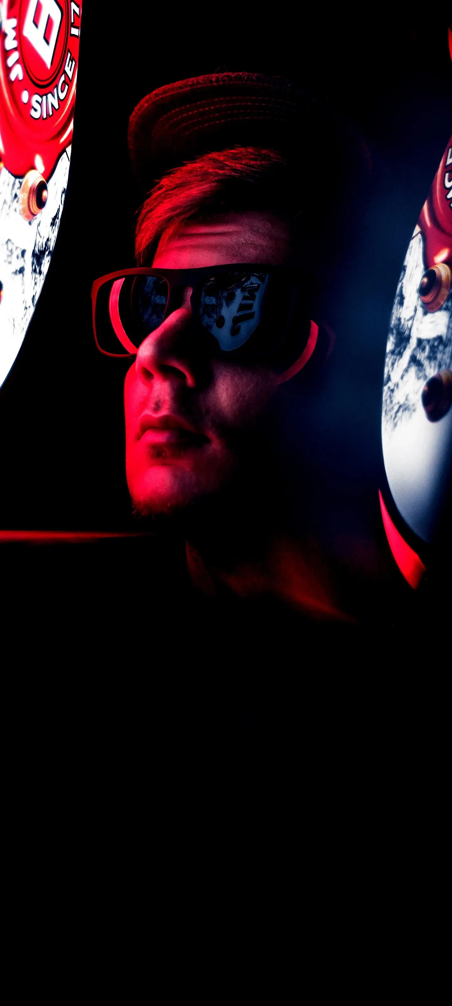 Dark Figure with Stylish Glass Standing in Dim Red Lights