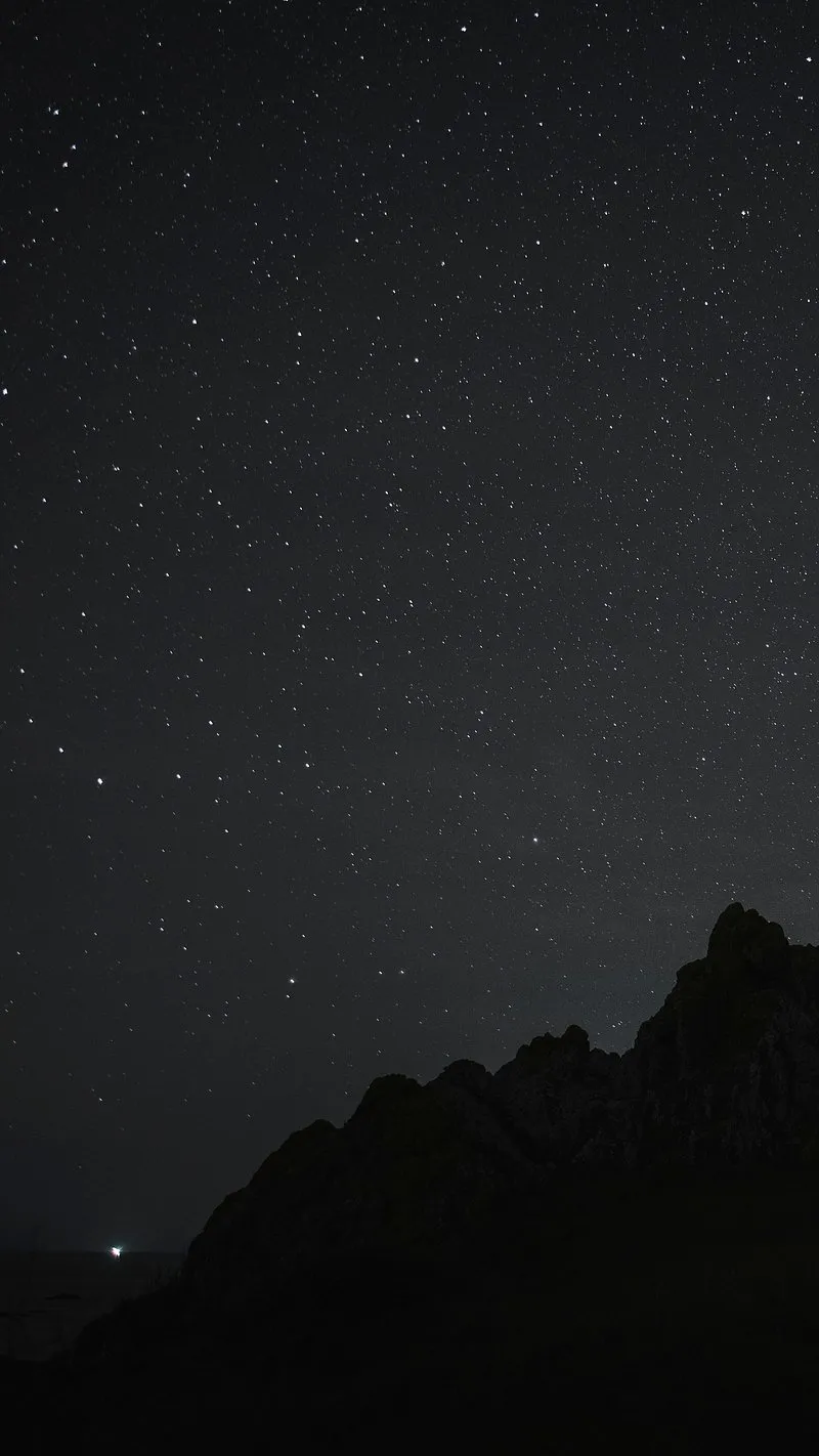 Dark Mountain Silhouette Under a Clear Starry Night Sky