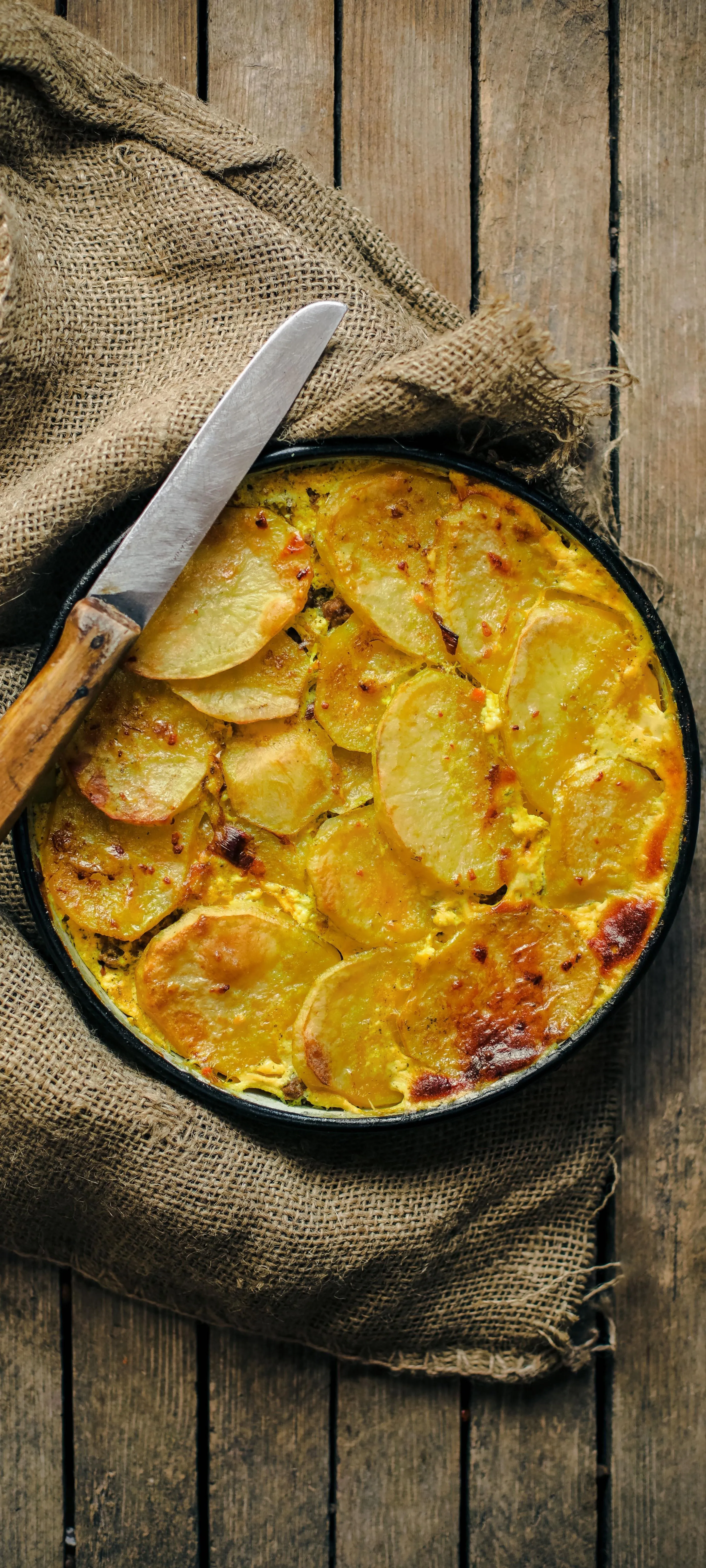 Delicious Baked Dish with Potato and Cheese in Rustic Pan