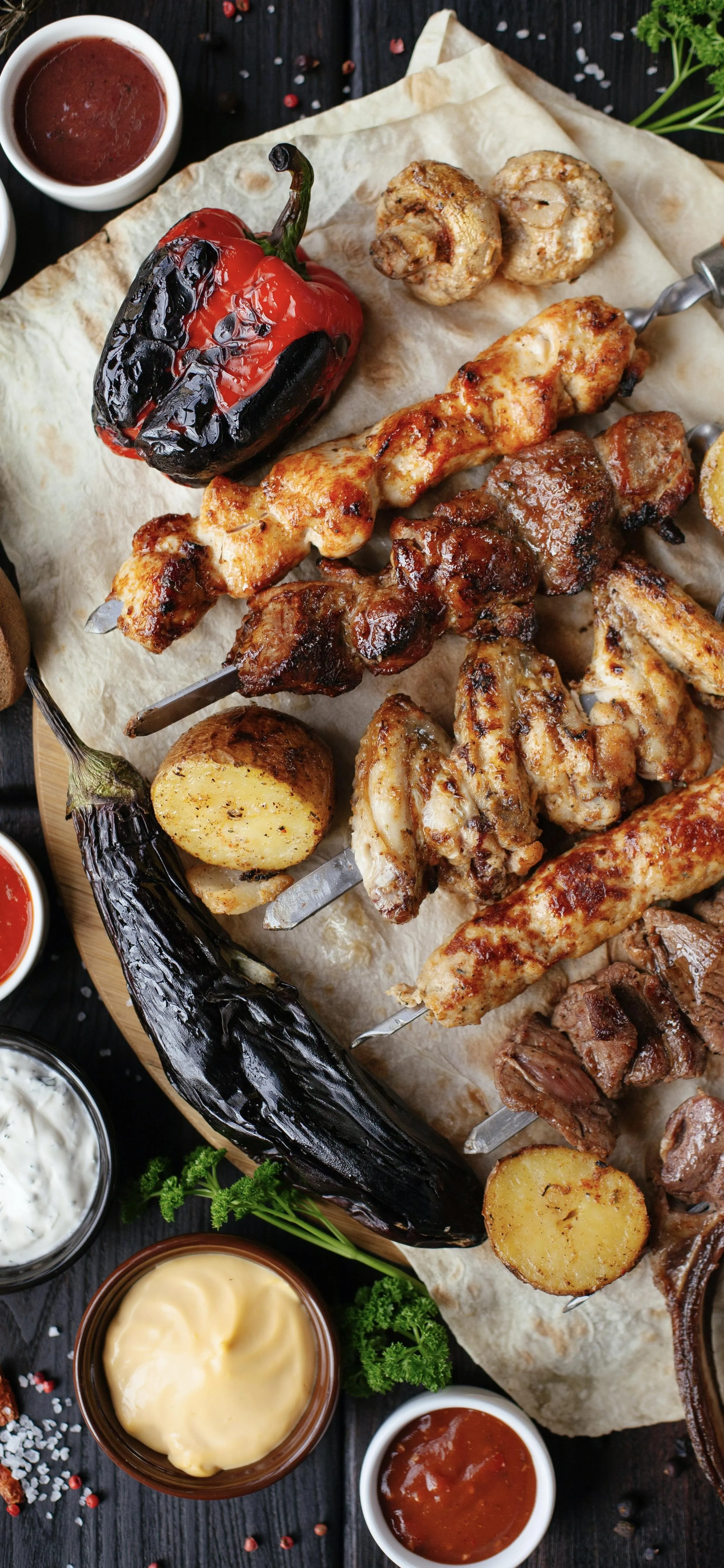 Delicious Grilled Meat Skewers with Various Sauces Image