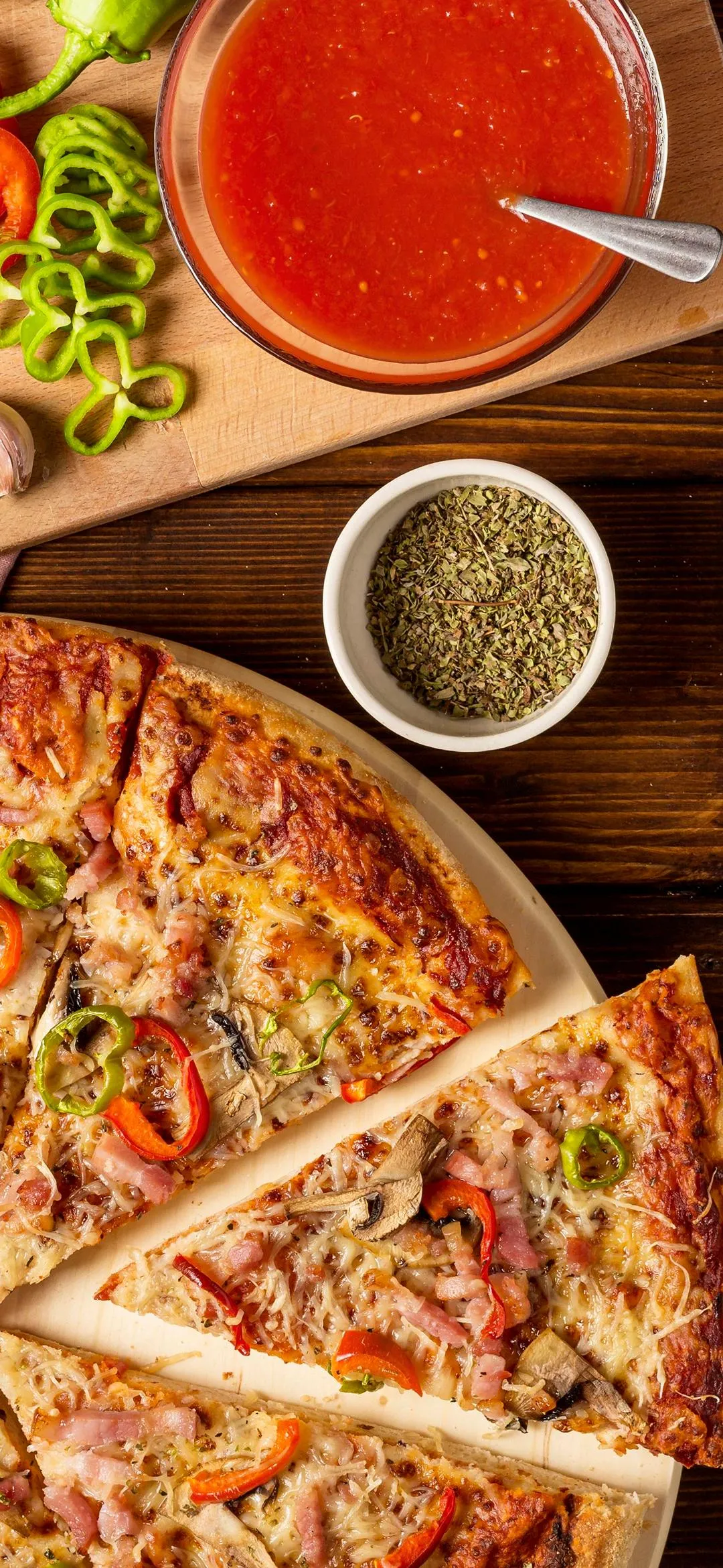 Delicious Pizza and Fresh Ingredients on Wooden Table