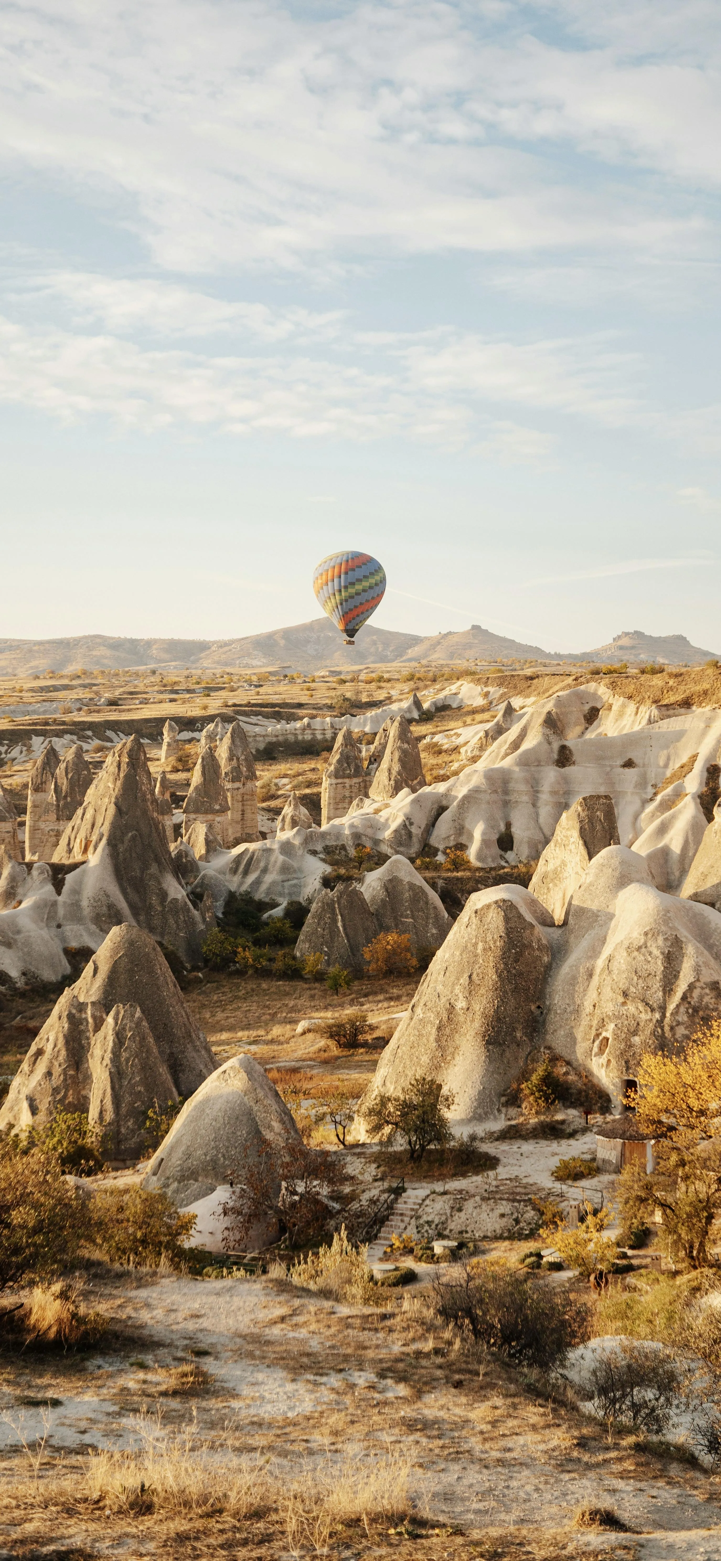 Desert Landscape with Hot Air Baloon Flying in Sky Image