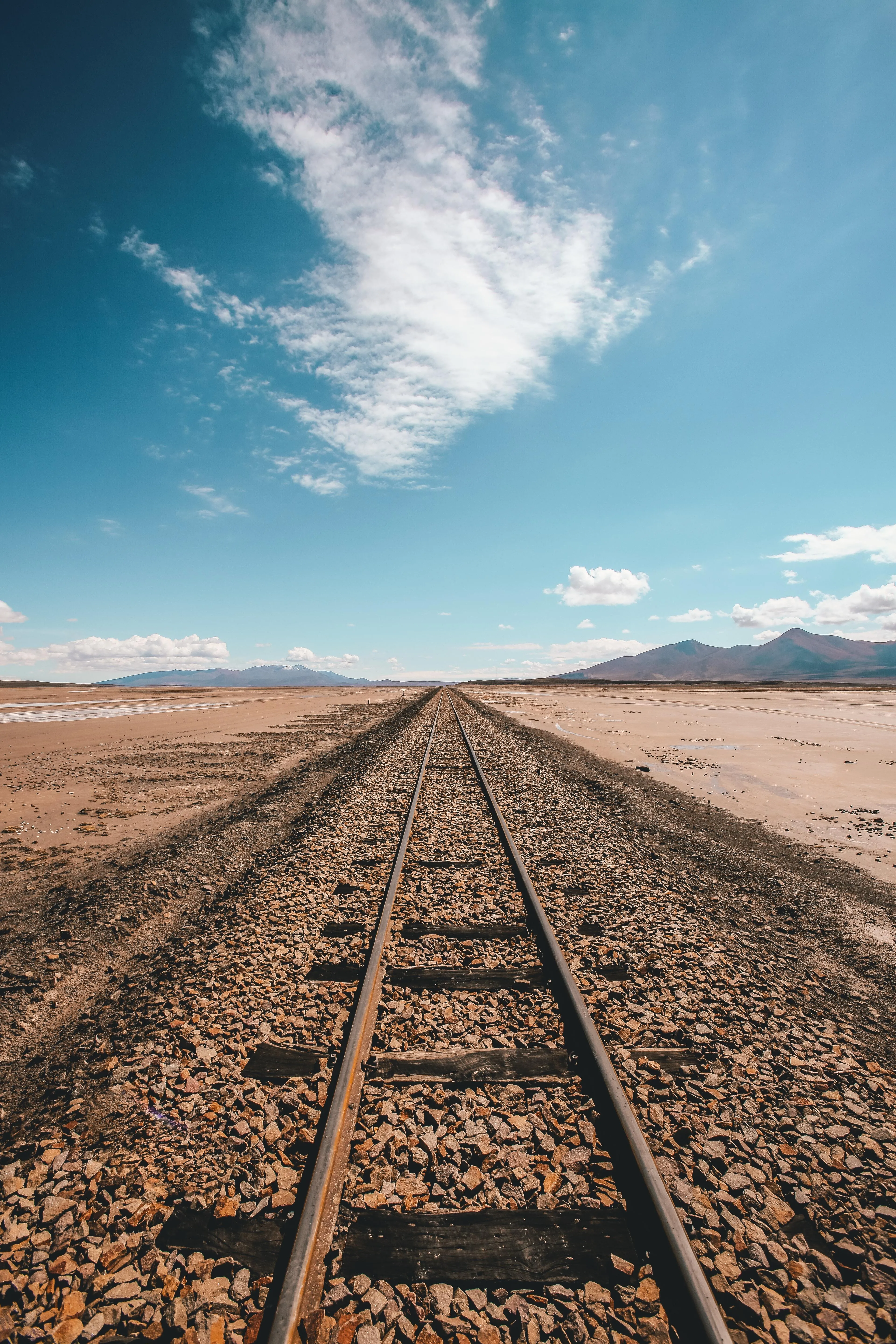 Desert Railway Tracks Under Blue Sky Horizon Wallpaper