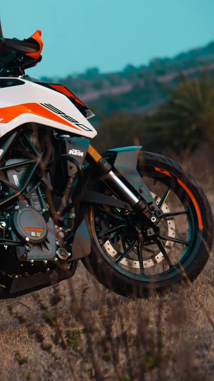 Dirt Bike Standing on Hill with Mountain Backdrop Wallpaper