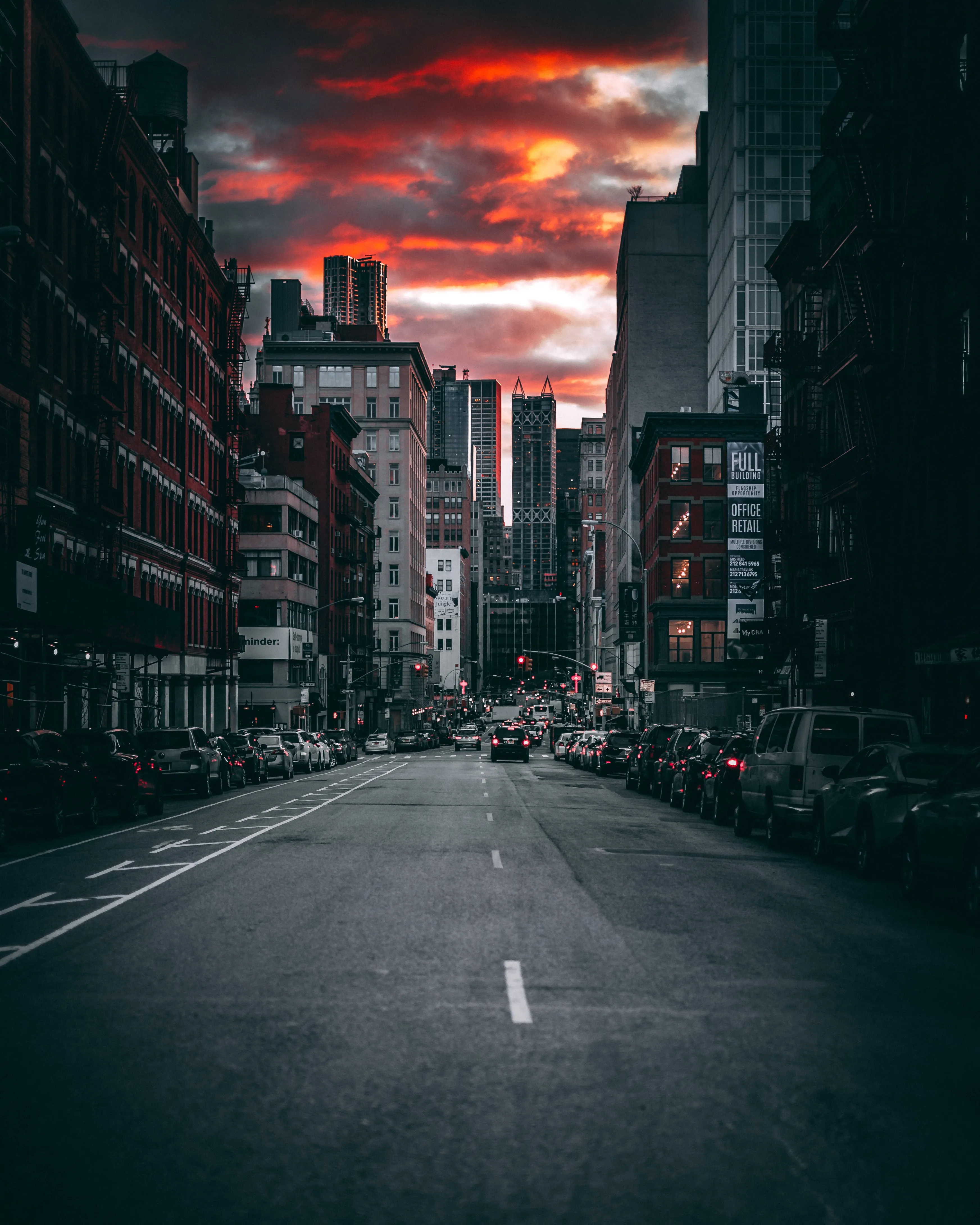 Empty City Street Under Red and Dark Stormy Sunset Sky