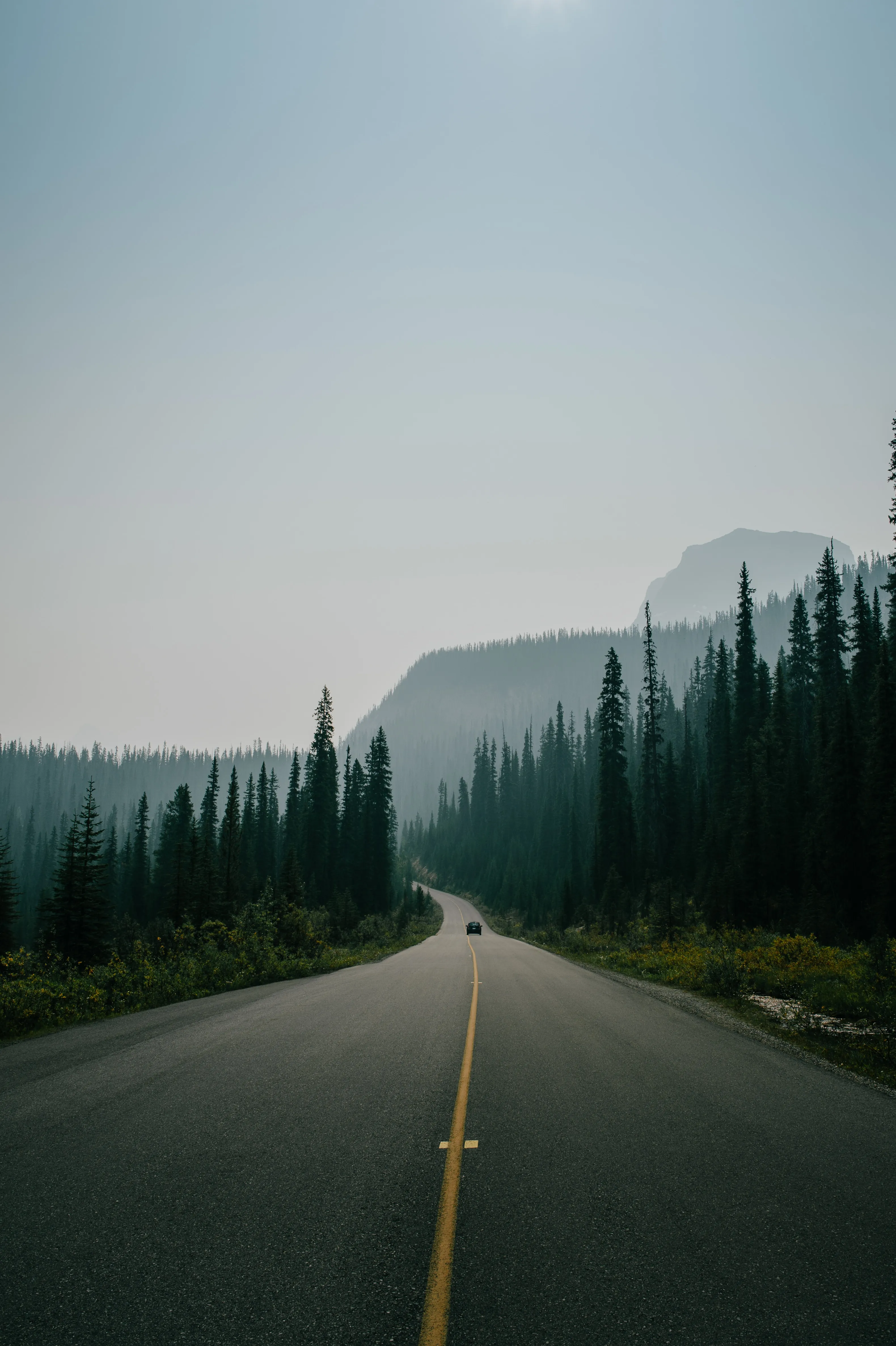 Empty Highway Leading to Mountain Horizon Wallpaper